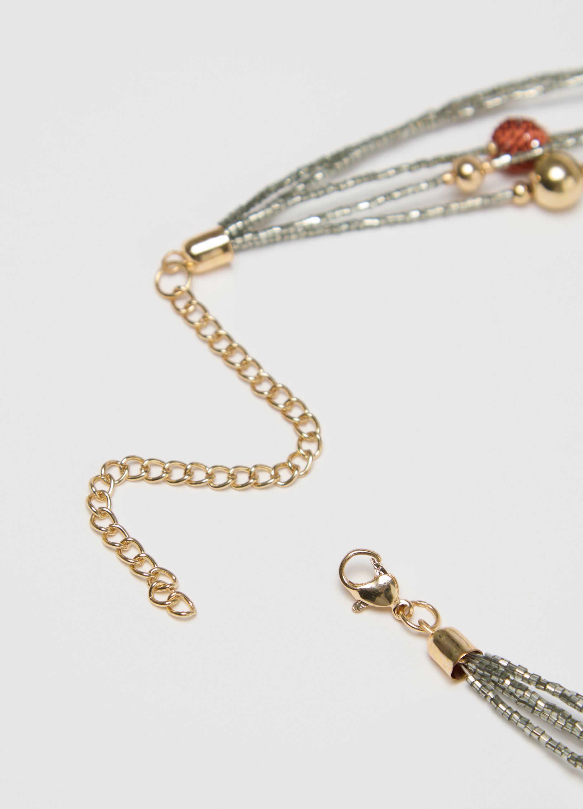 Multi-strand necklace with coloured spheres