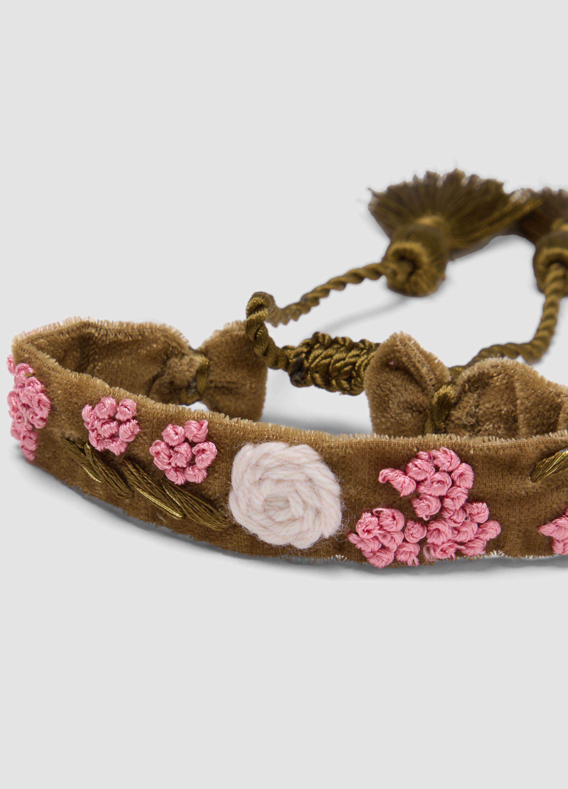 Green bracelet with embroidered flowers and tassels