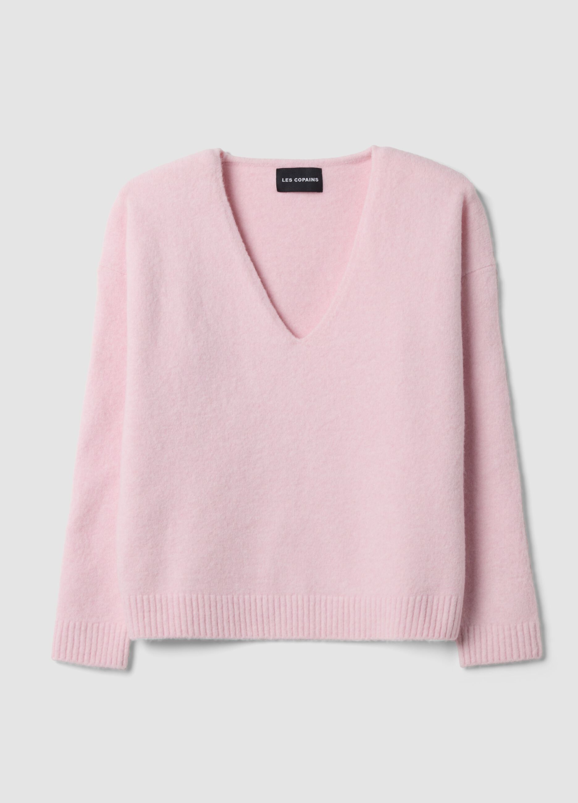 Pink stretch wool jumper with deep V-neck and oversized fit