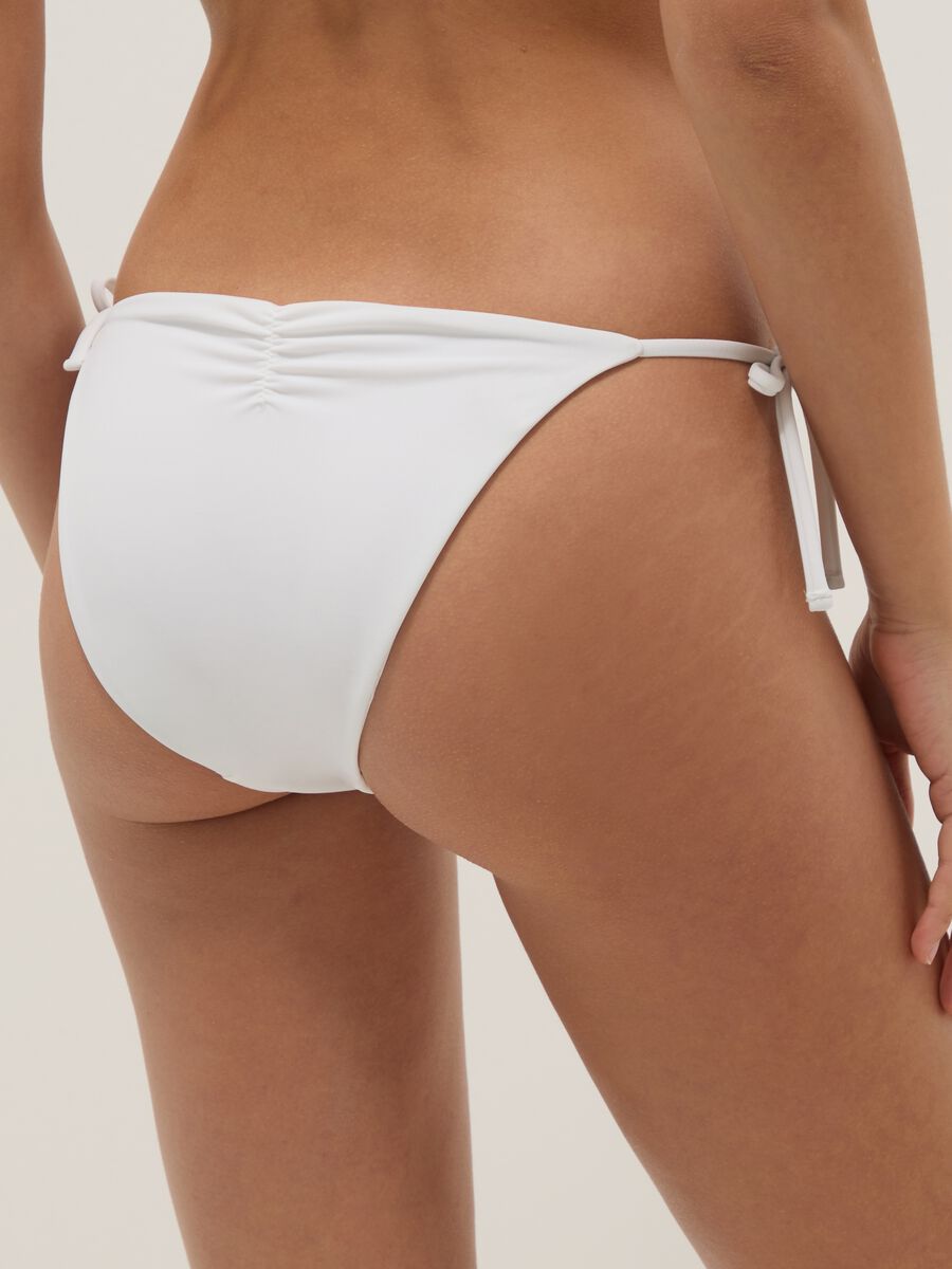 White stretch bikini bottoms with decorative beads_2