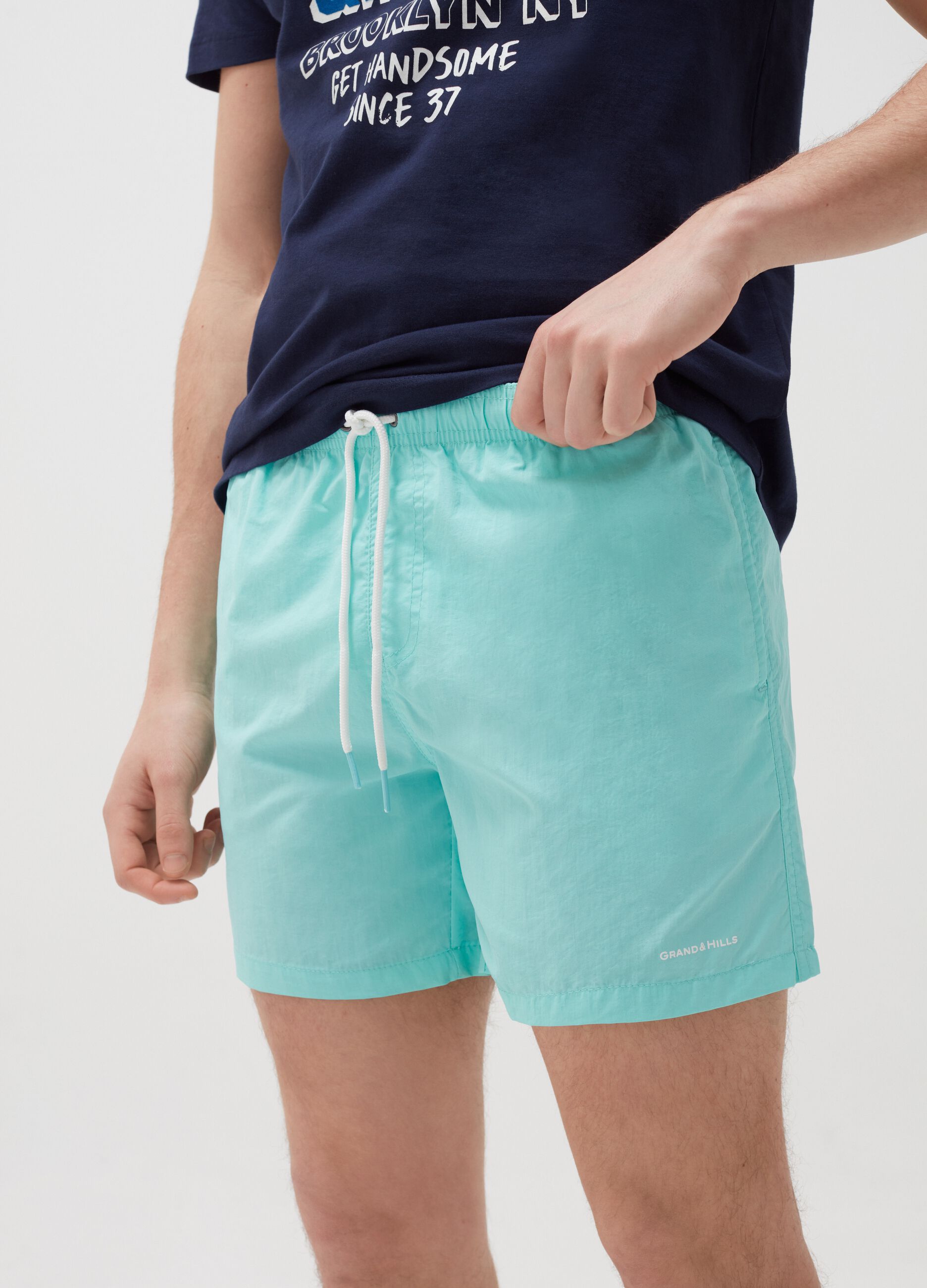 Swimming trunks with lettering print