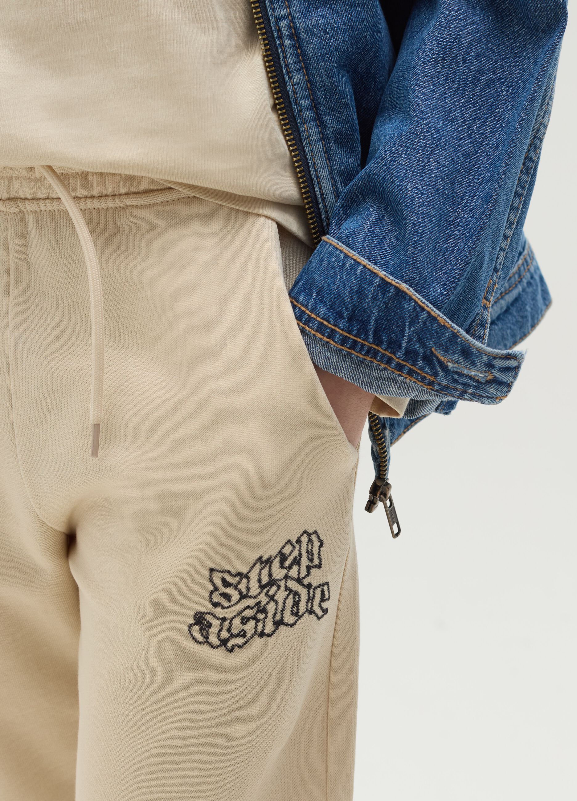 Joggers with drawstring and "Step Aside" print