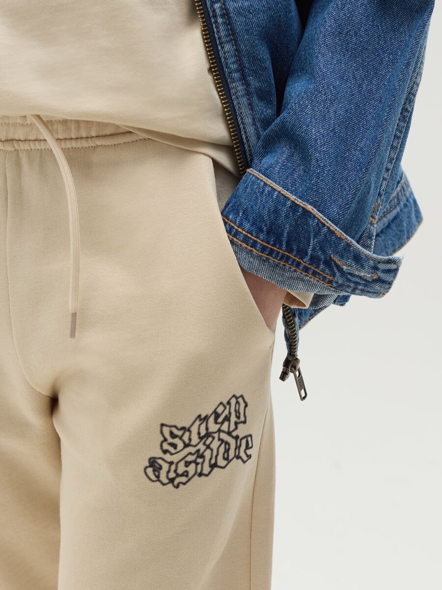 Joggers with drawstring and "Step Aside" print_3
