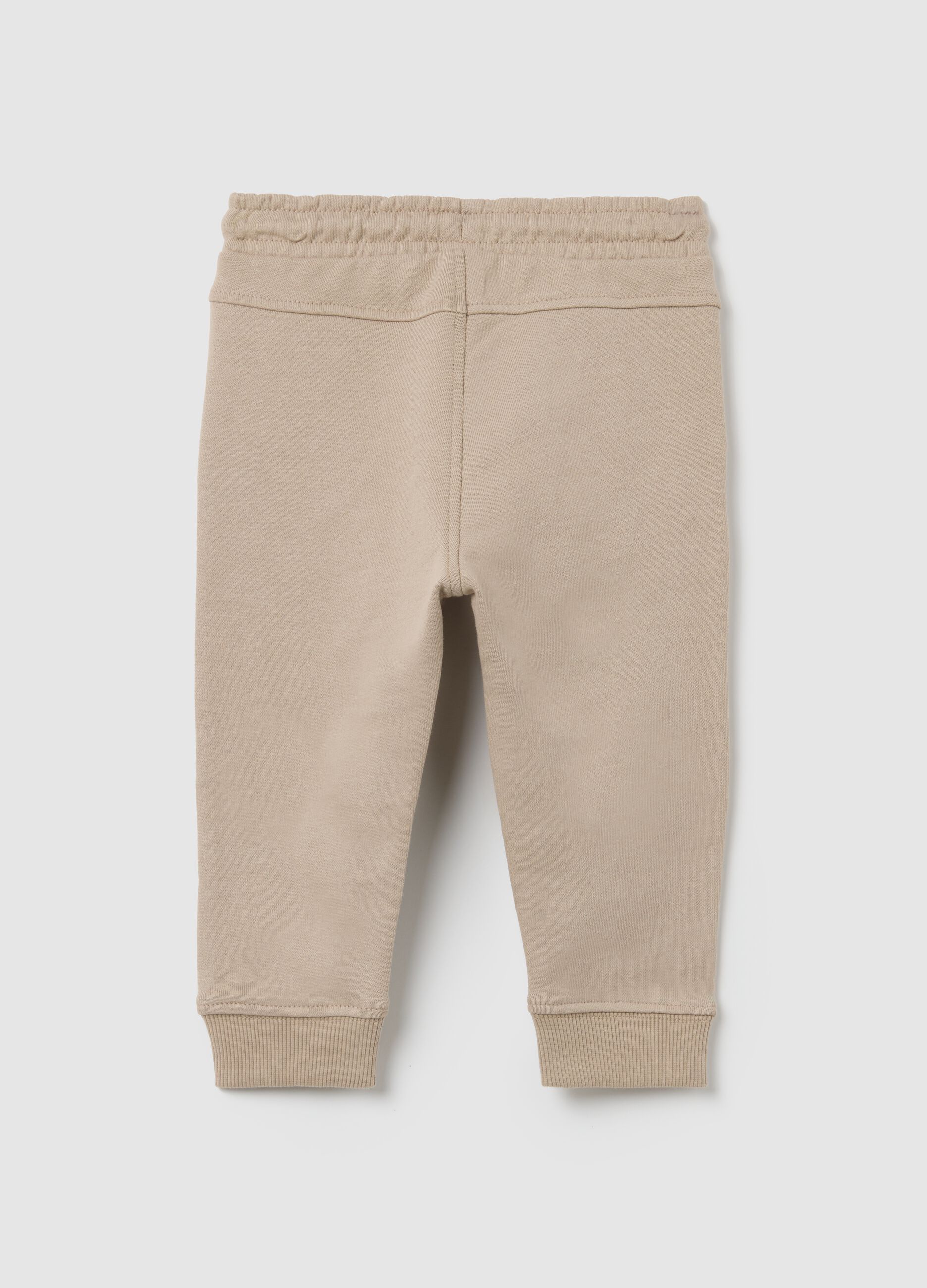 Baby trousers in pure beige cotton with dog print