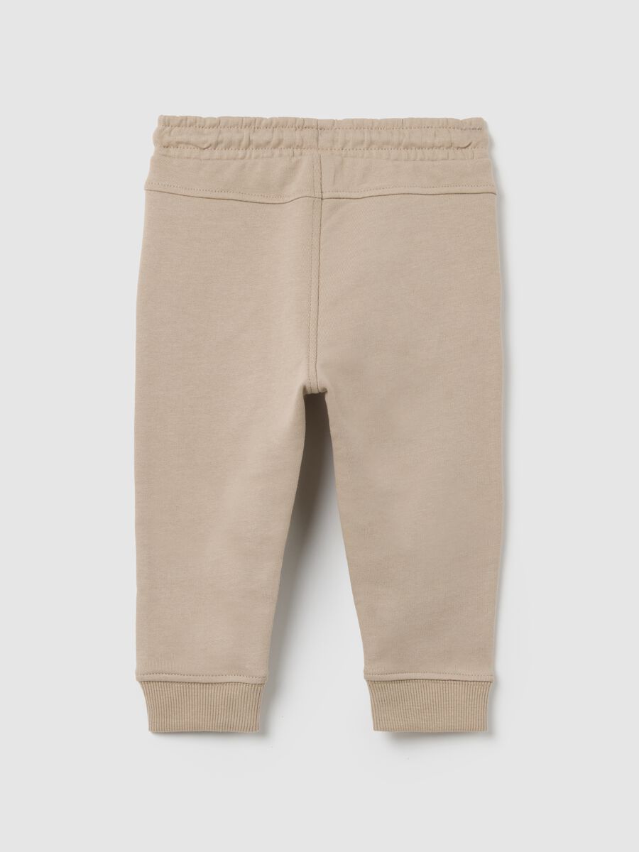 Baby trousers in pure beige cotton with dog print_1