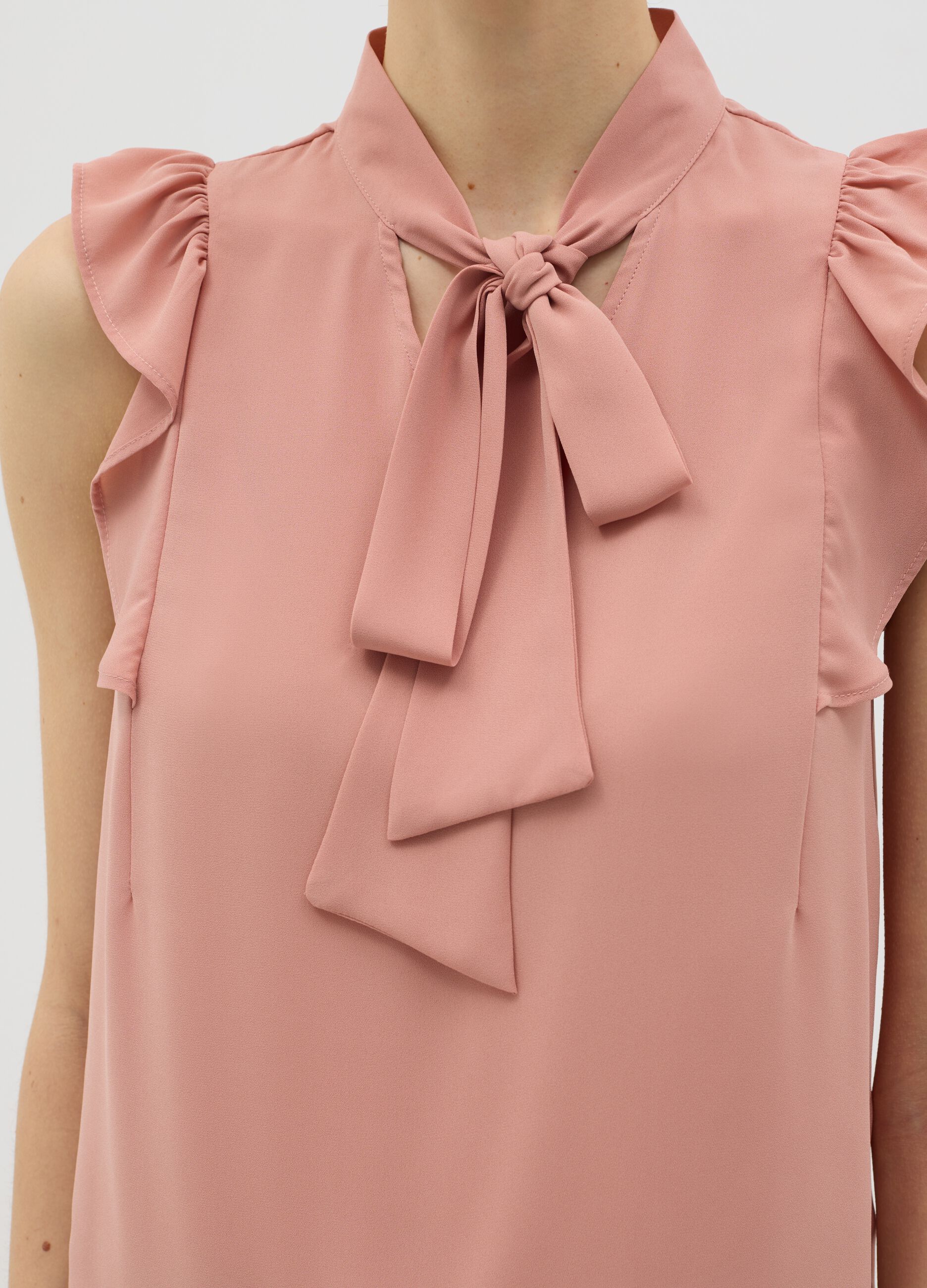 Pink sleeveless blouse with flounce