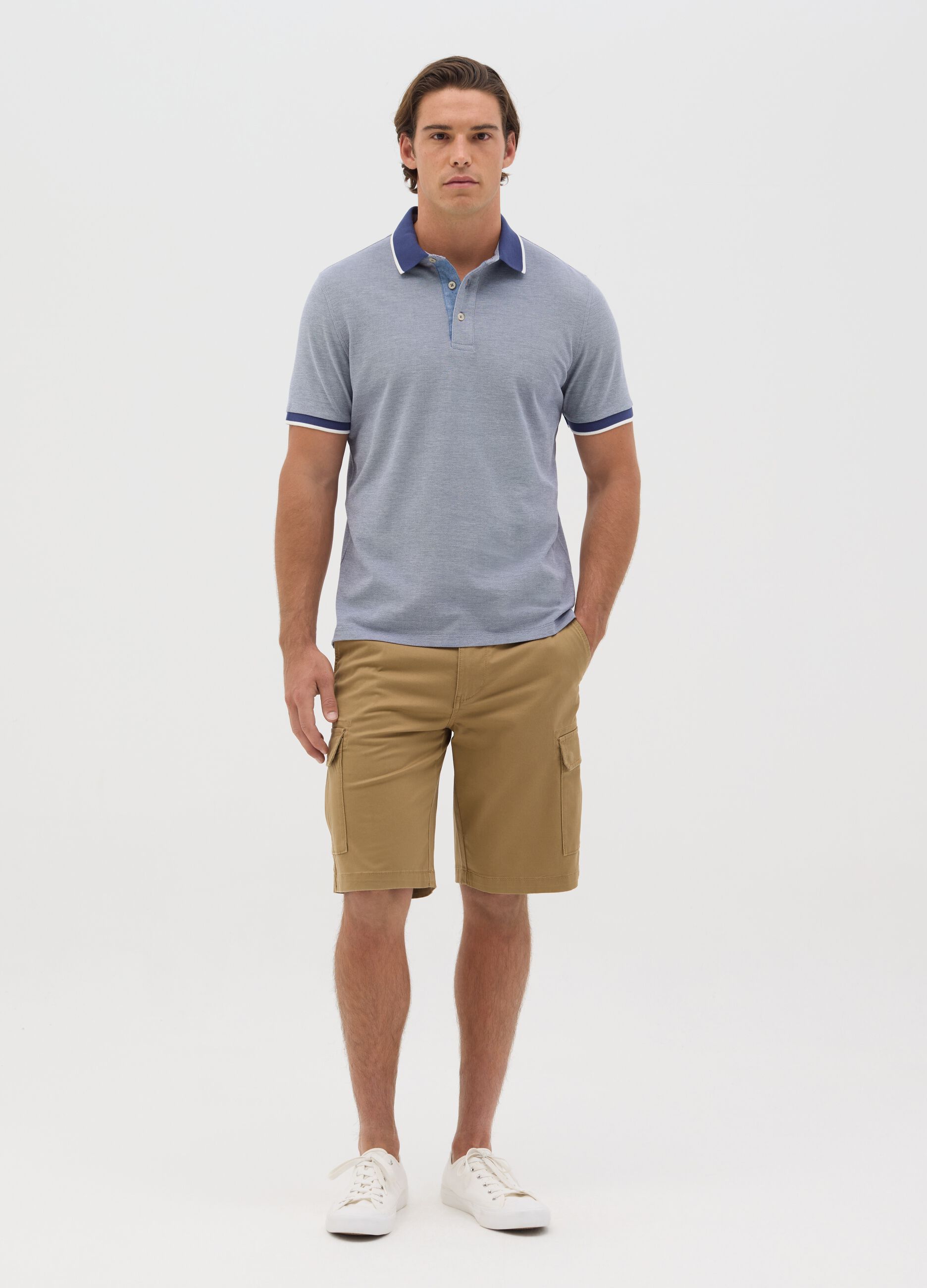 Blue polo shirt with short sleeves in cotton piquet