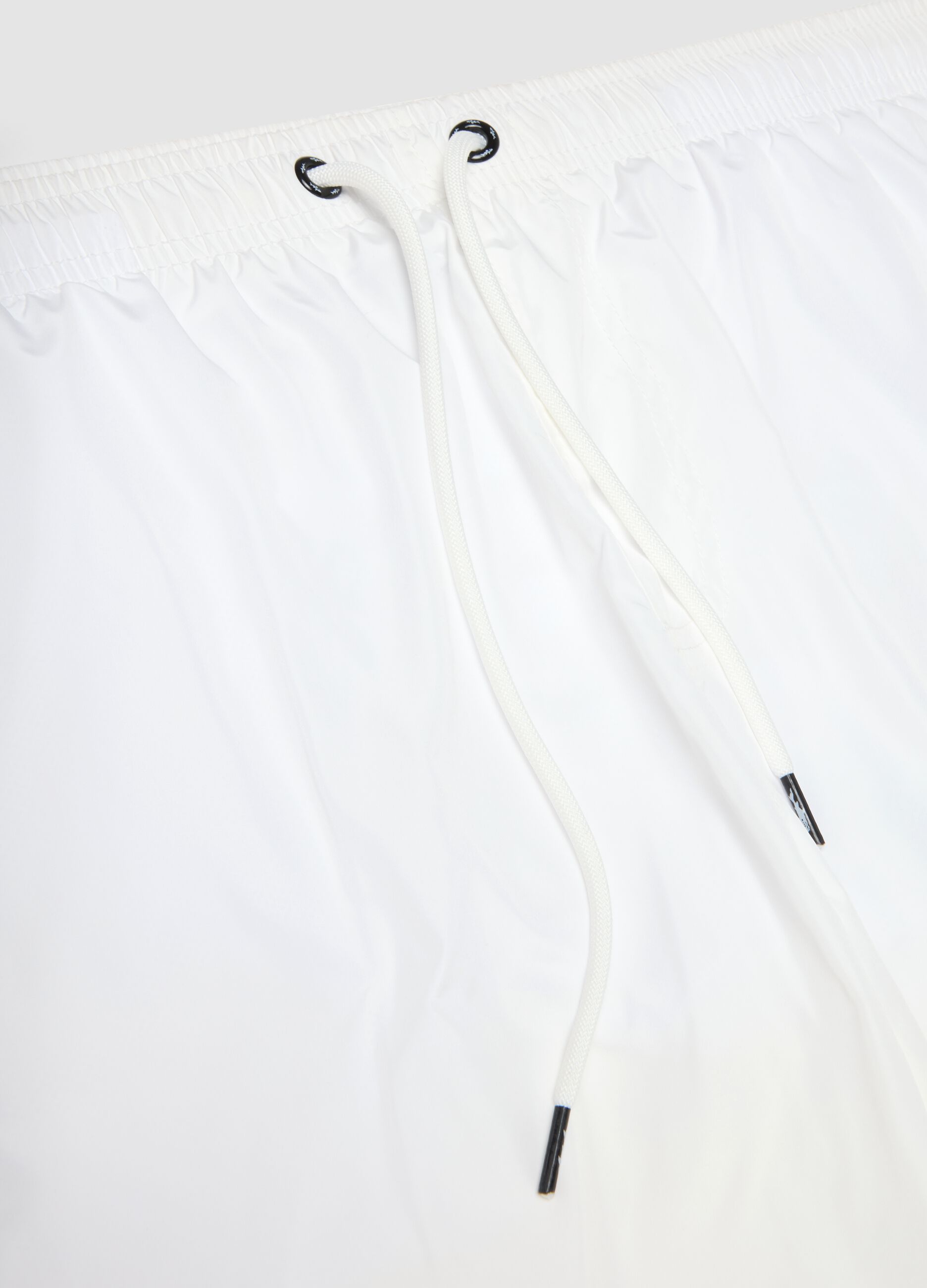 White swim shorts with elasticated waistband