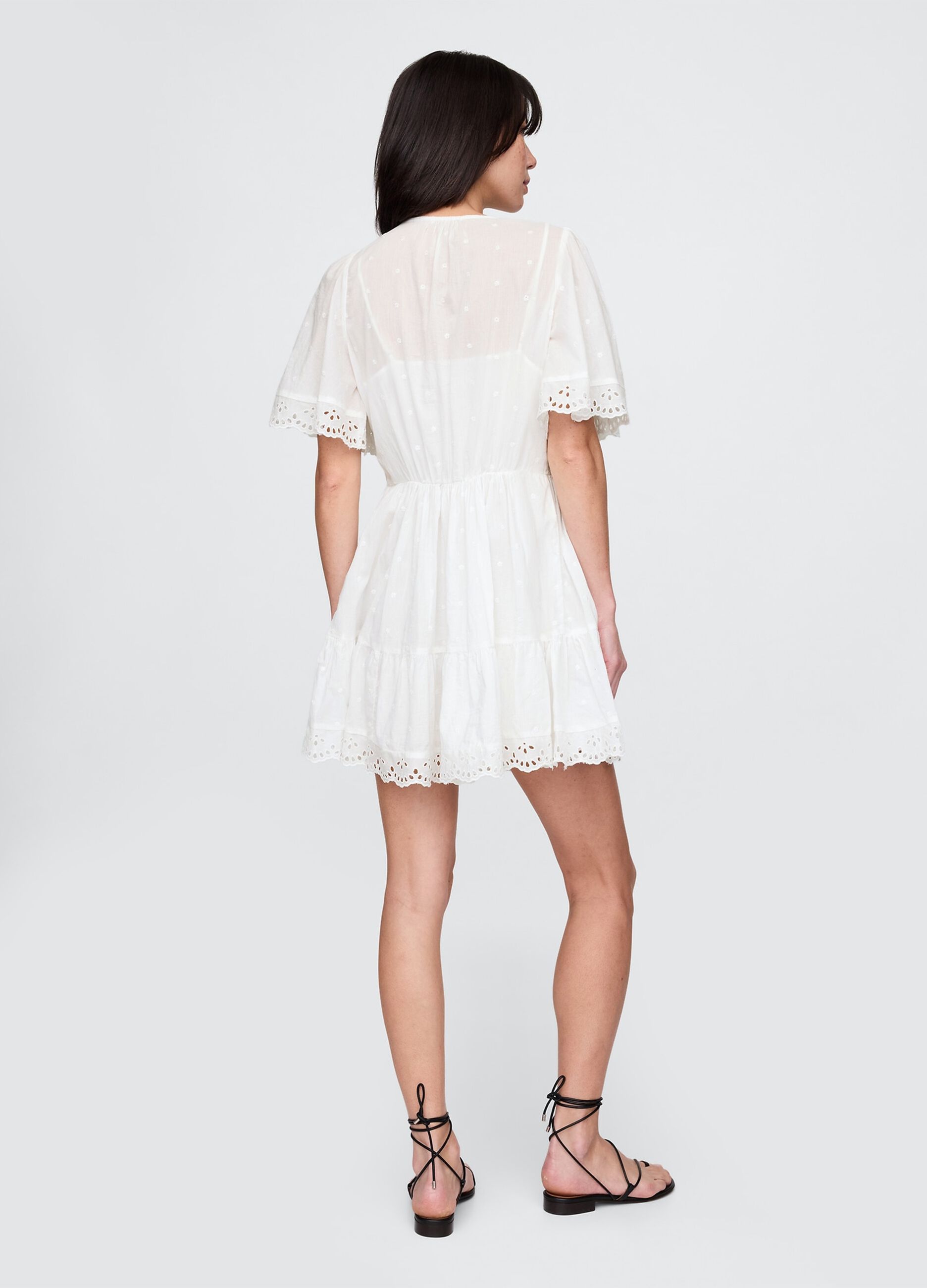 Short white dress in embroidered fabric