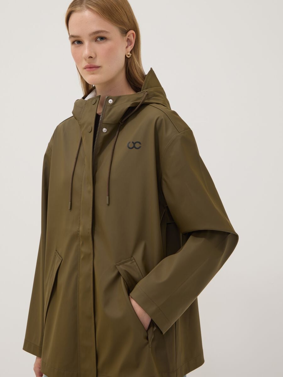 Giacca antipioggia verde con zip e cappuccio_1