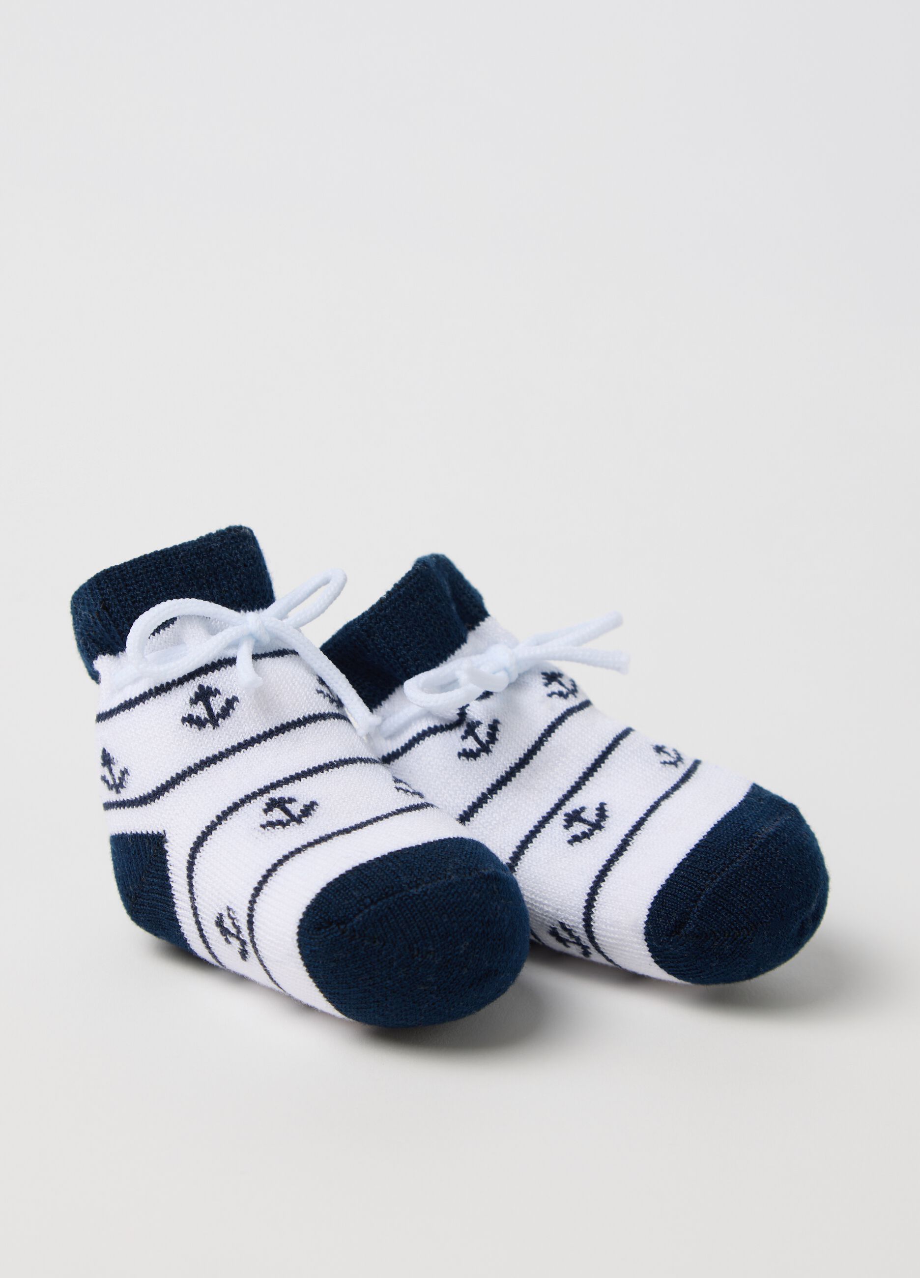 White and blue knit shoes with anchors embroidery