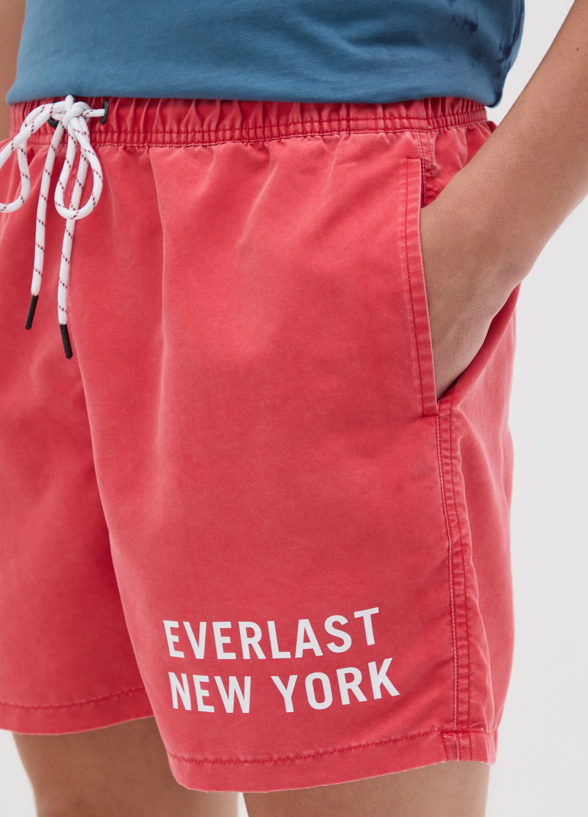Red swimming trunks with logo print