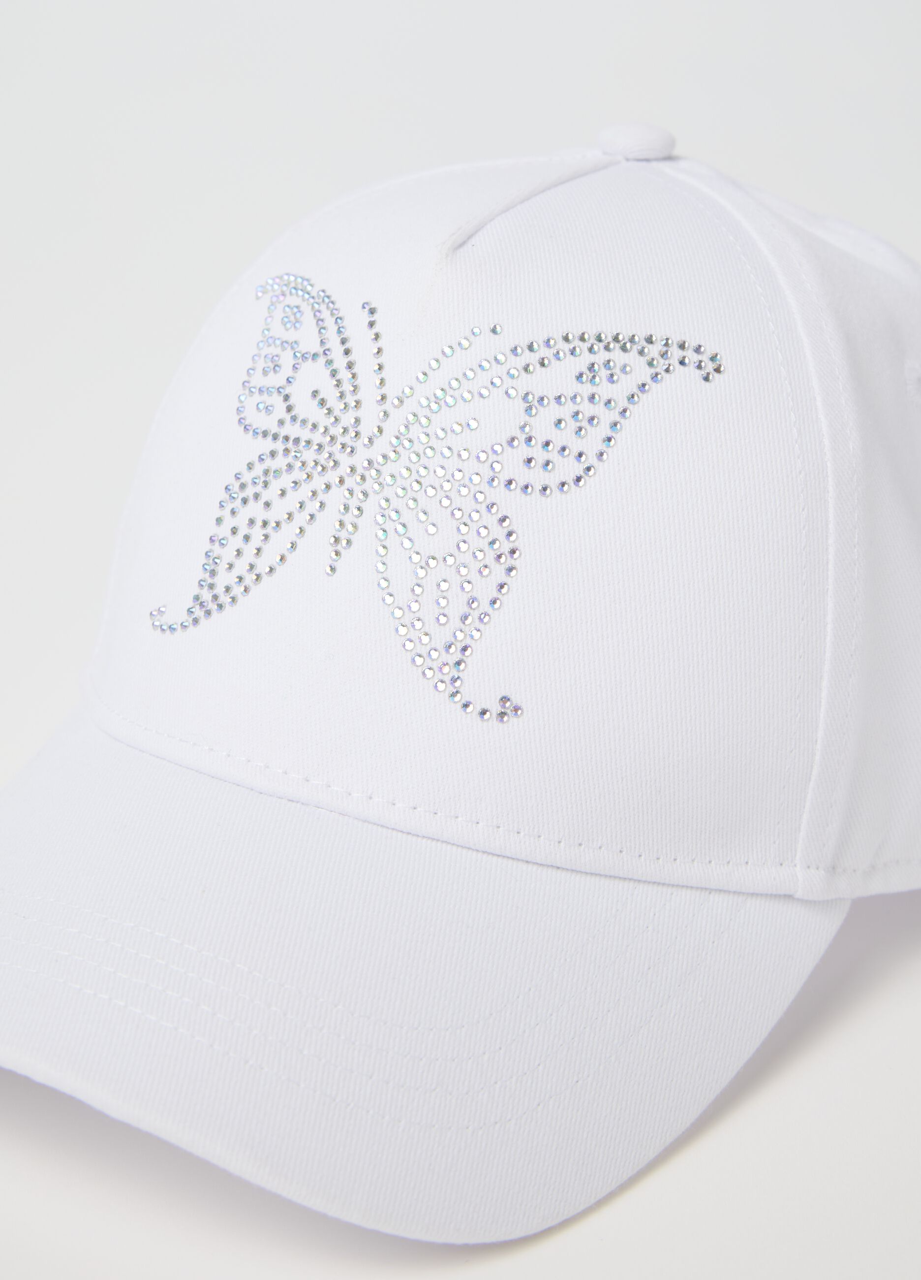 White baseball cap with butterfly embellishment