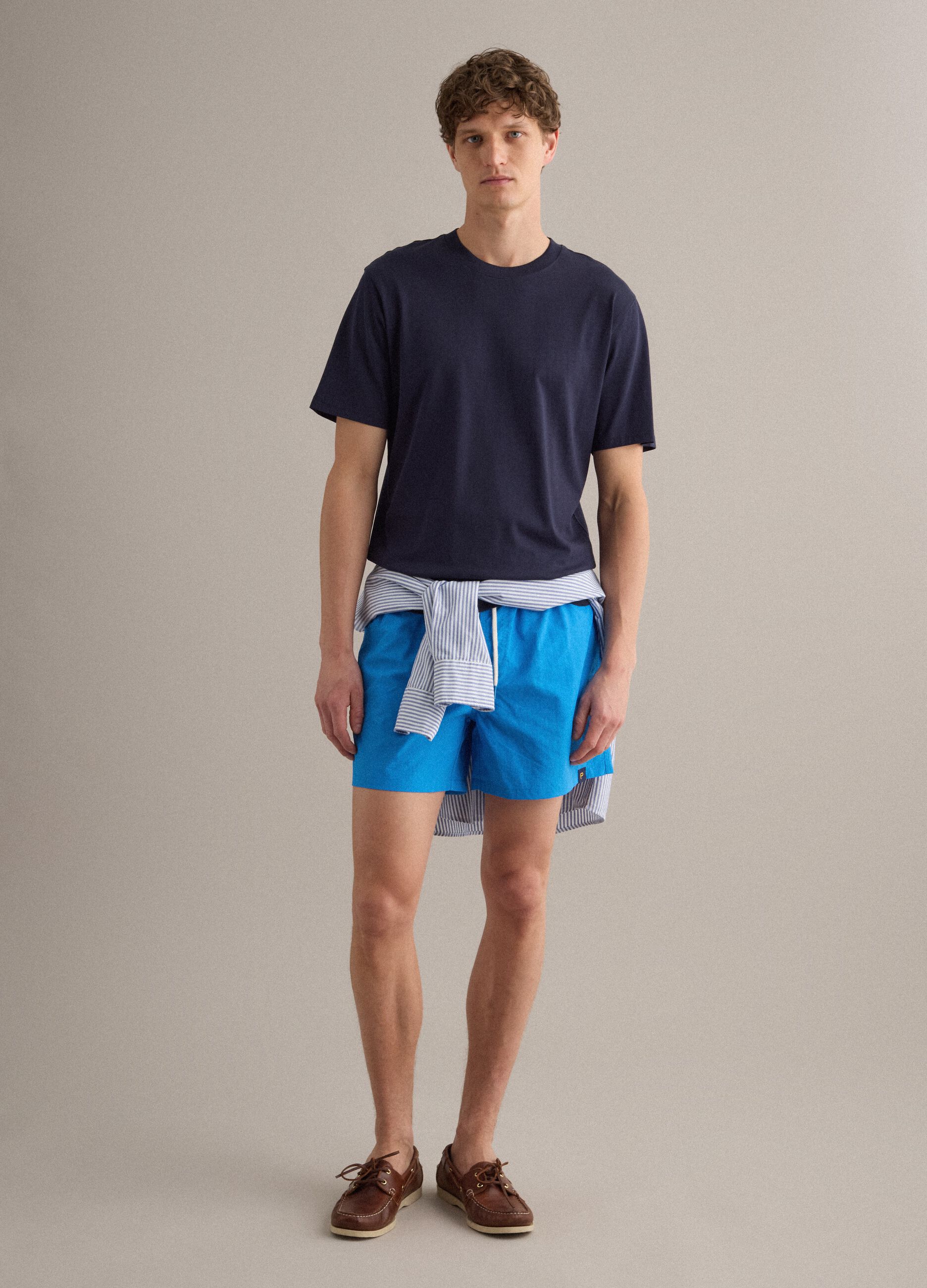Blue swim shorts with elasticated waistband and contrast drawstring