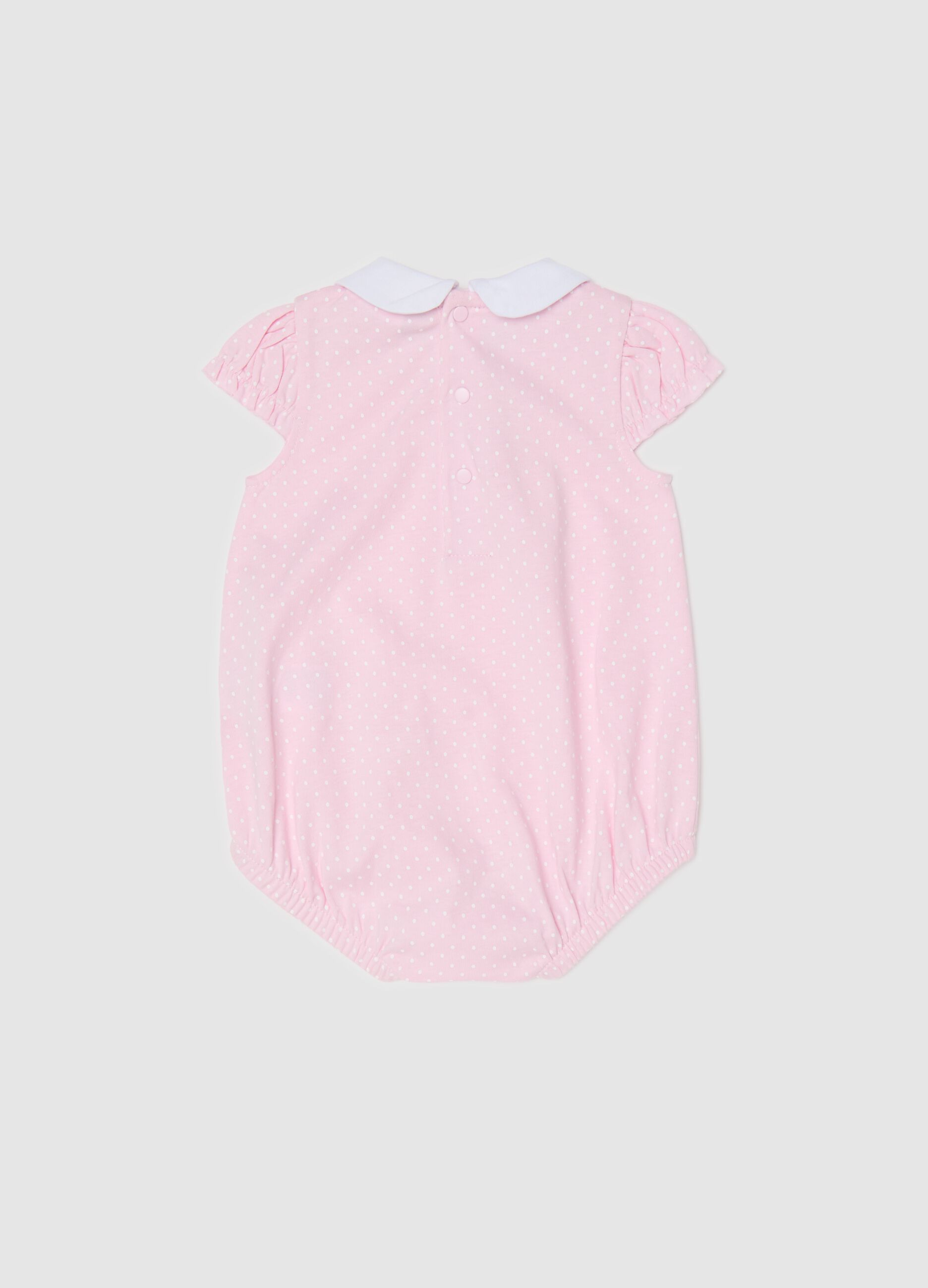 Pink romper suit in organic cotton with micro polka dot pattern