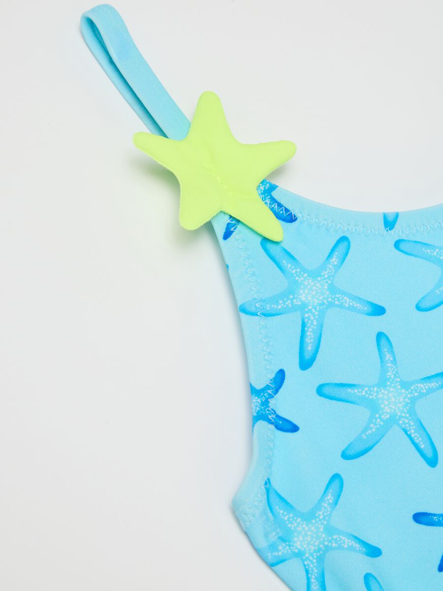 Girls’ one-piece swimsuit in light blue stretch fabric with starfish design_2