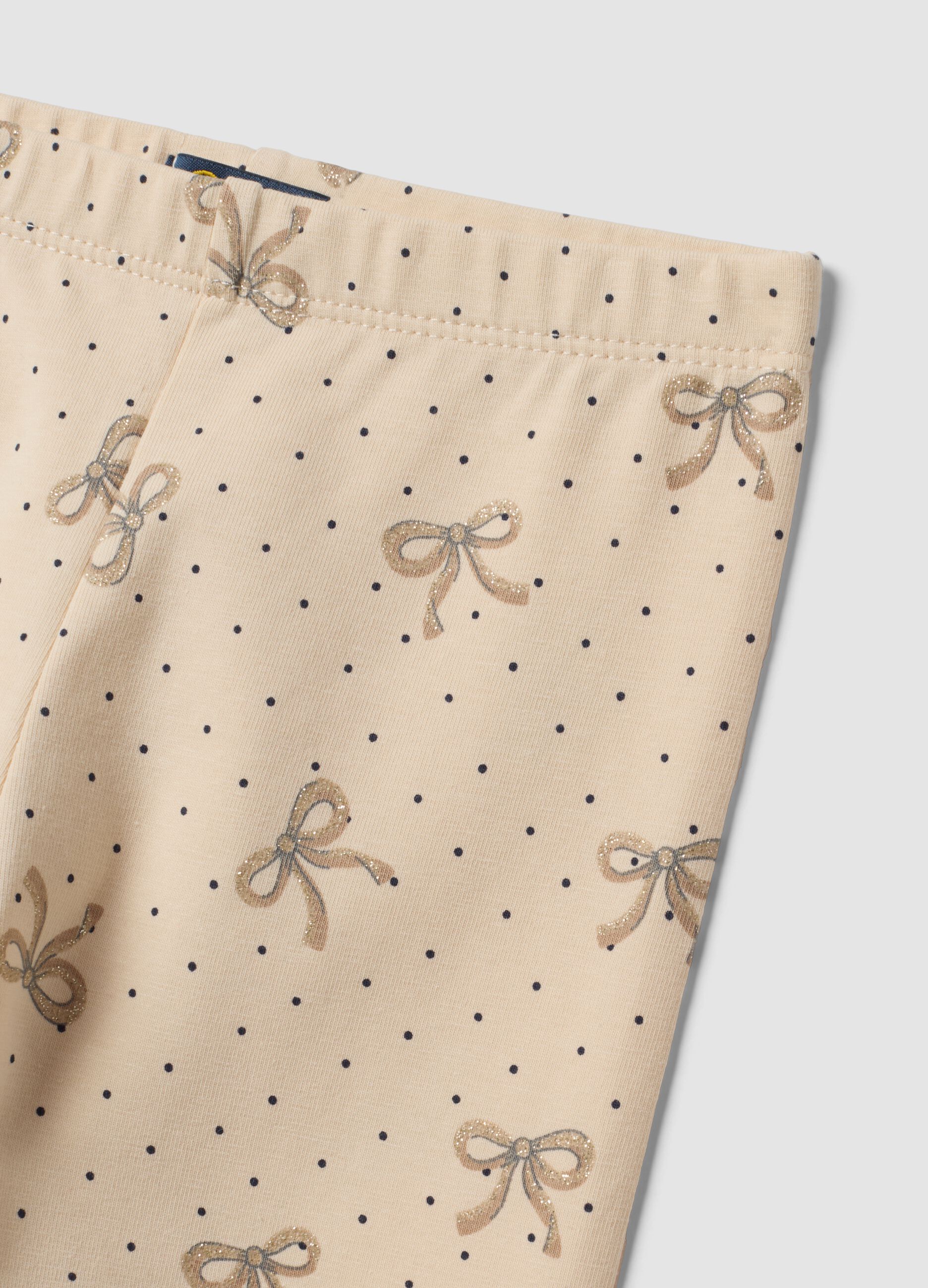 Leggings skinny beige in cotone organico elasticizzato con fiocchi per bambina