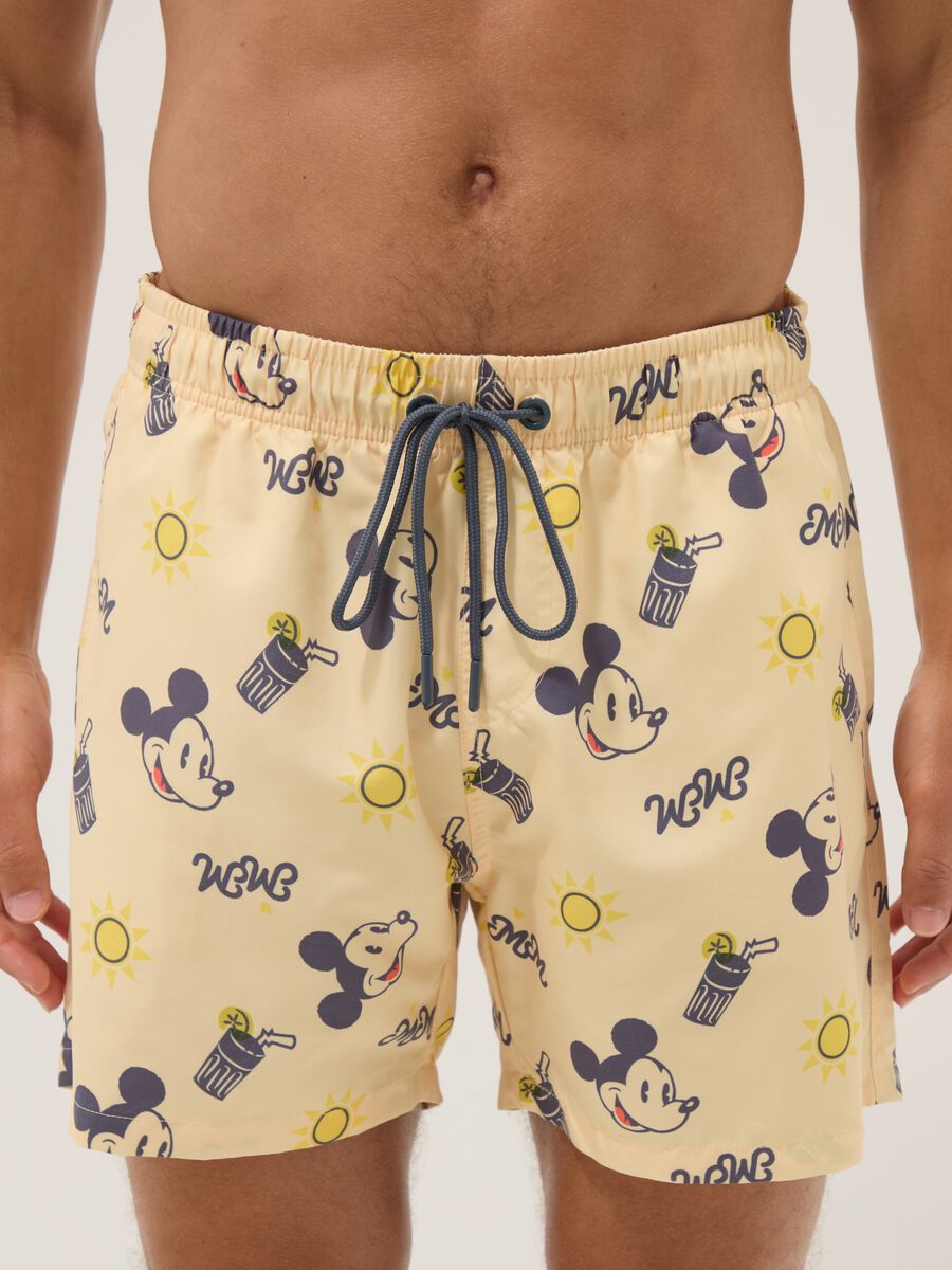 Orange swim trunks with Mickey Mouse prints_1