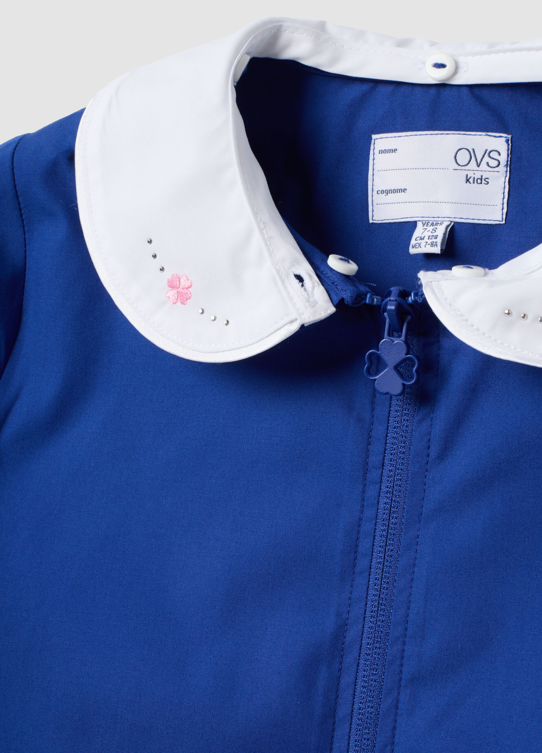 Blue girls&rsquo; school apron with rhinestone details and floral embroidery