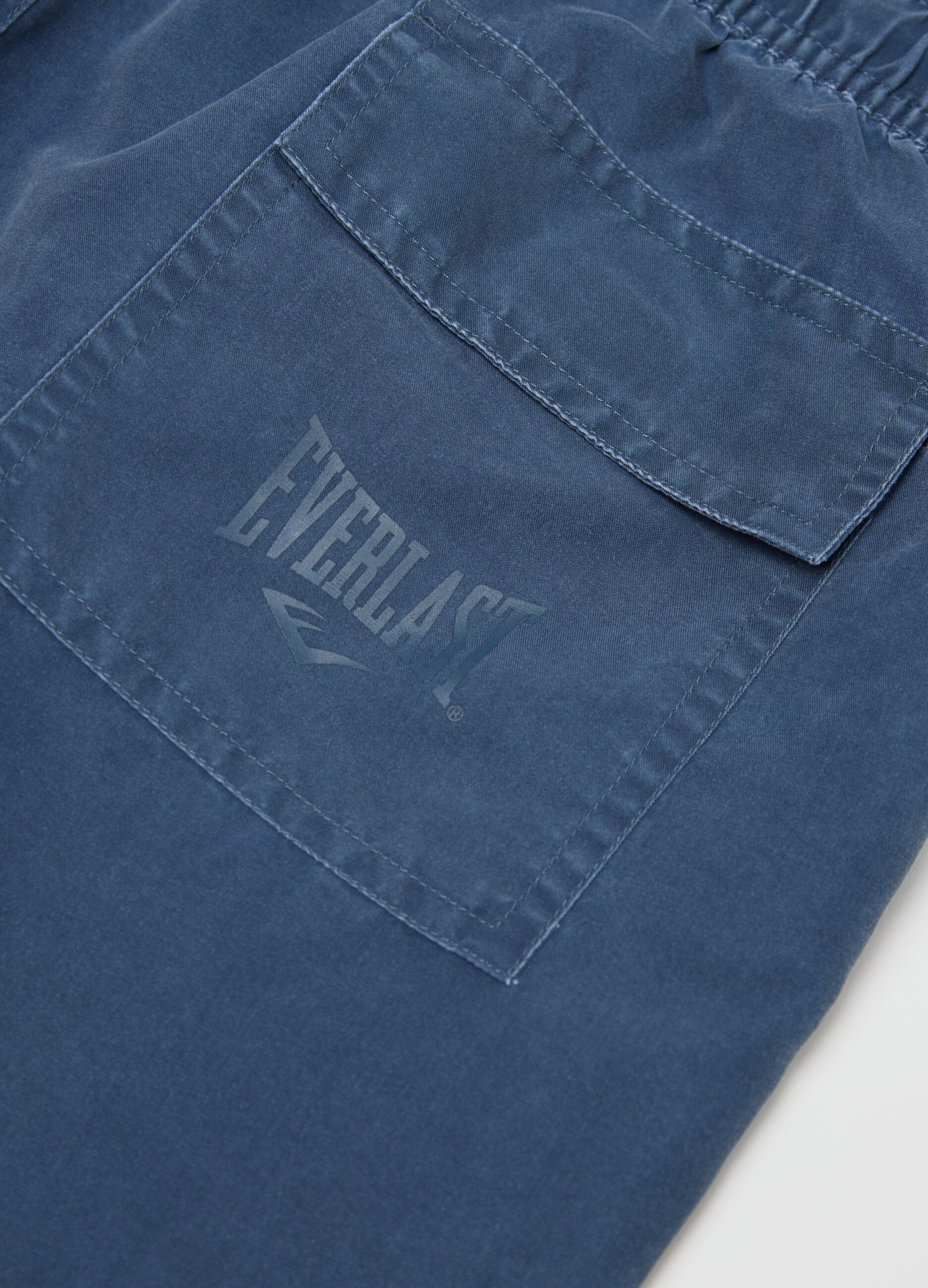 Blue swimming trunks with logo print