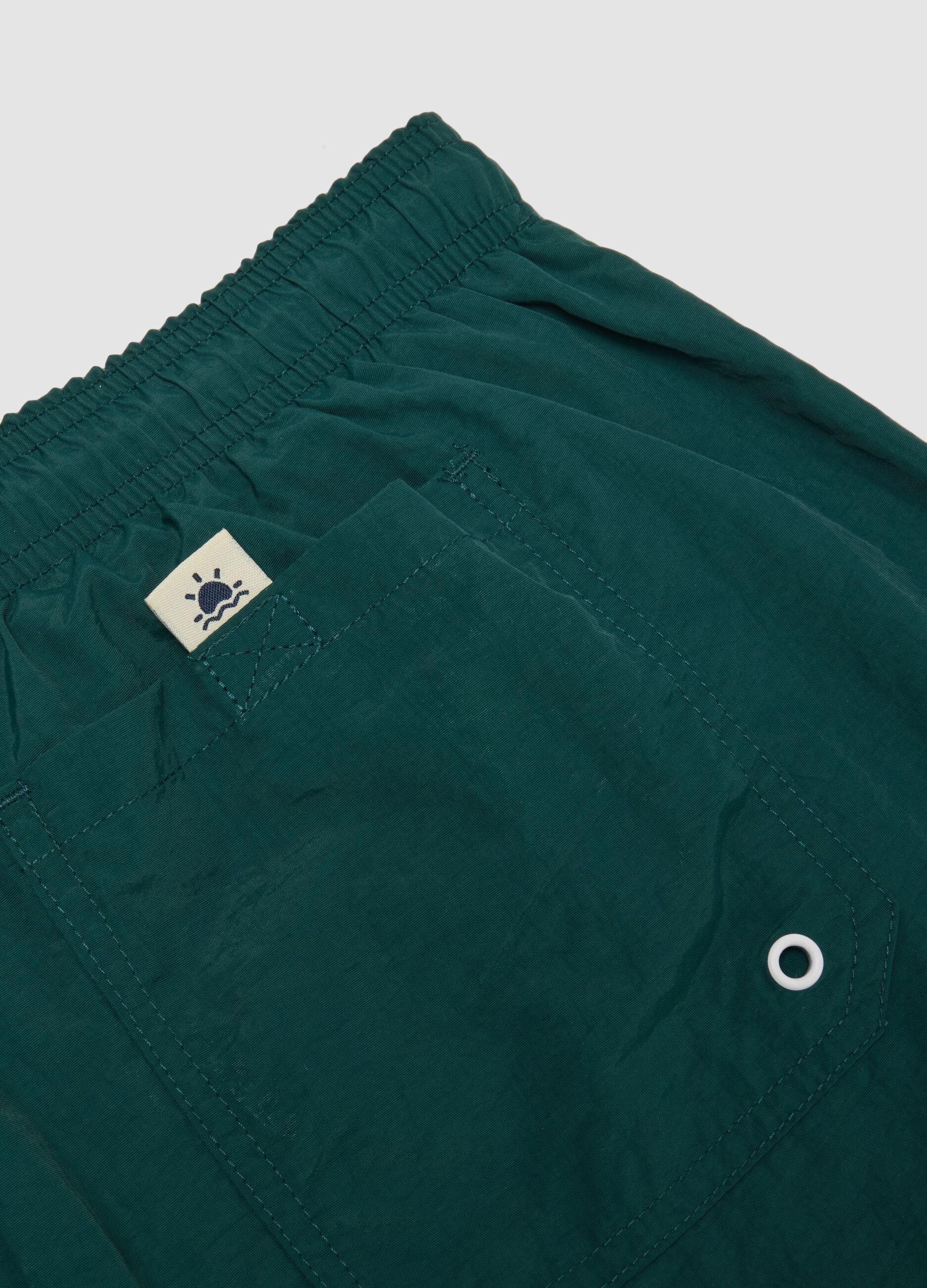 Green swim shorts with elasticated waistband