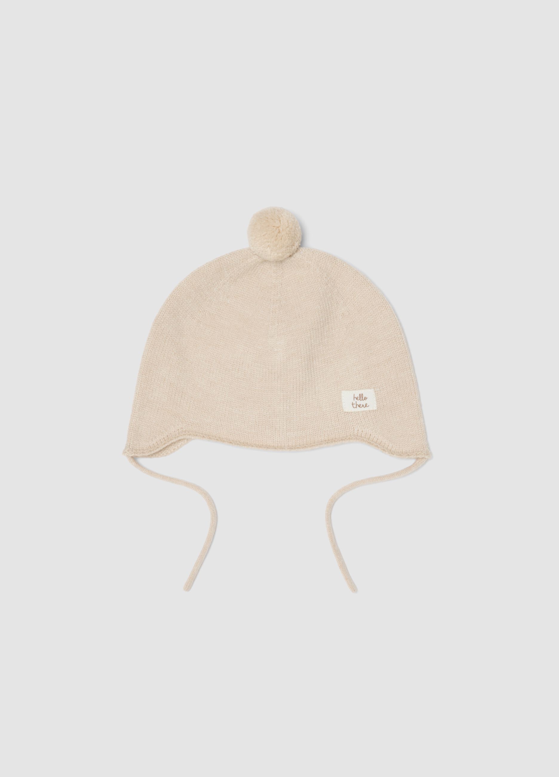 Cappellino beige melange in maglia con pon pon