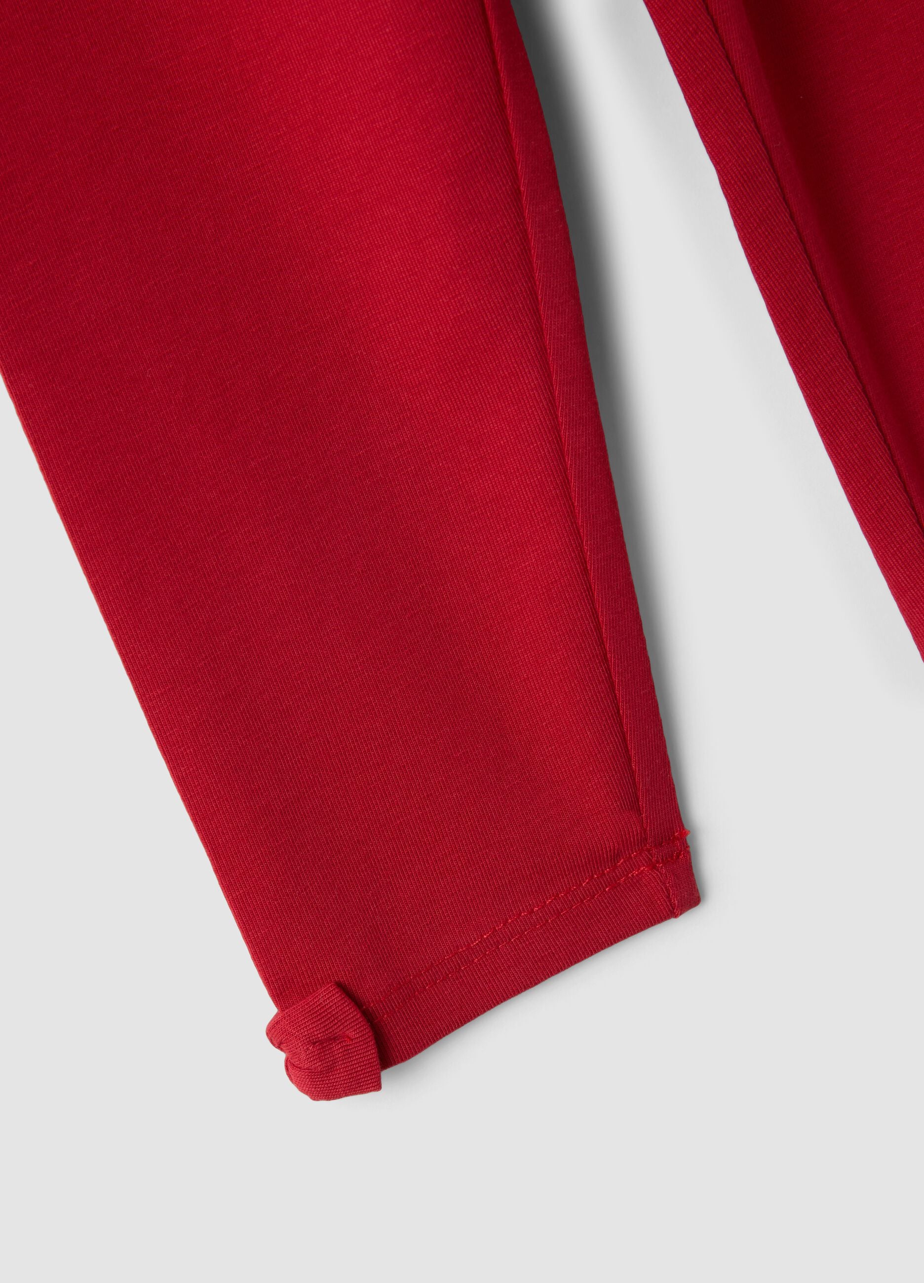 Red stretch organic cotton leggings with bow details for baby girl