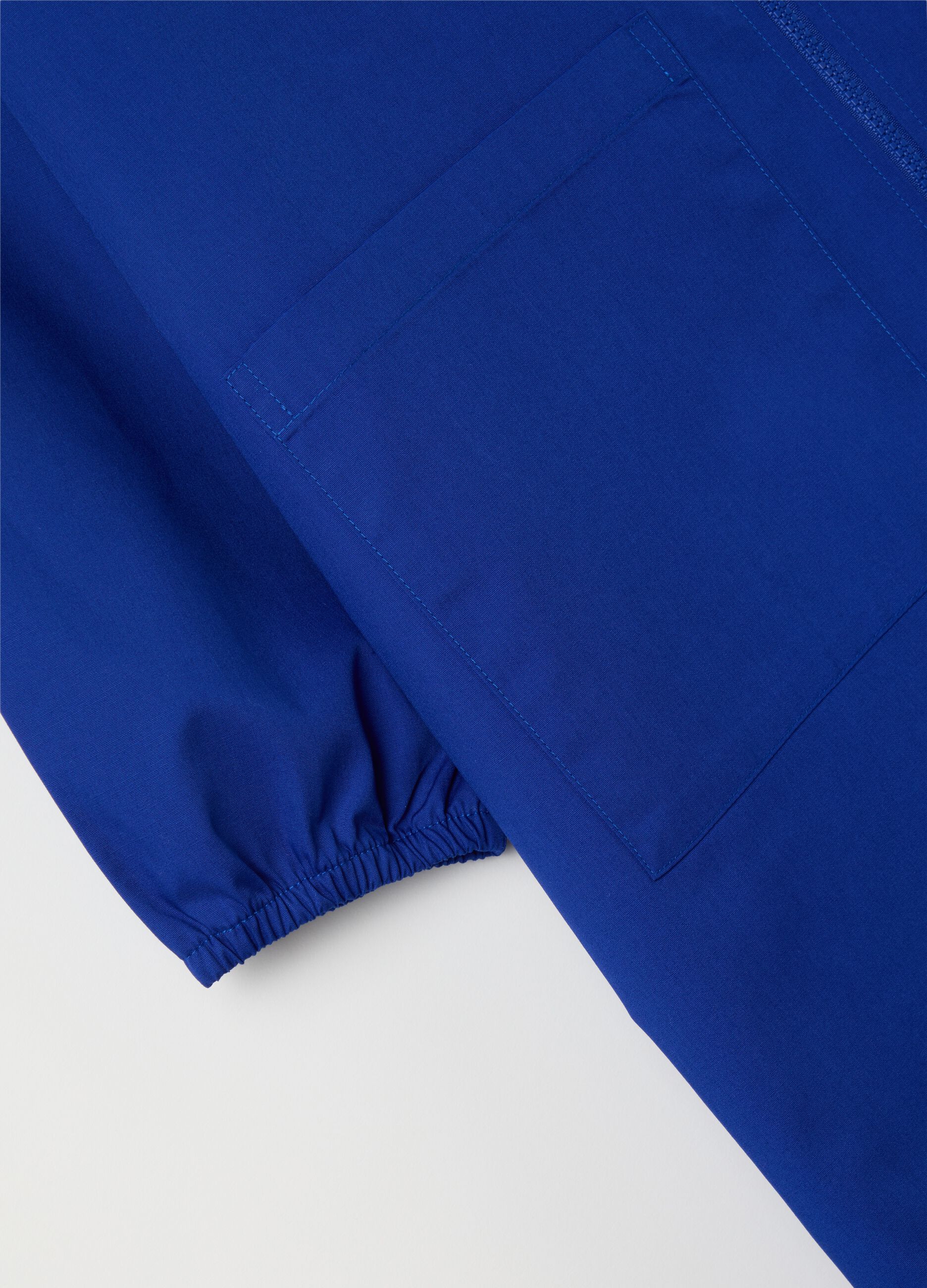 Blue cotton blend school smock for children with white collar featuring Super Mario