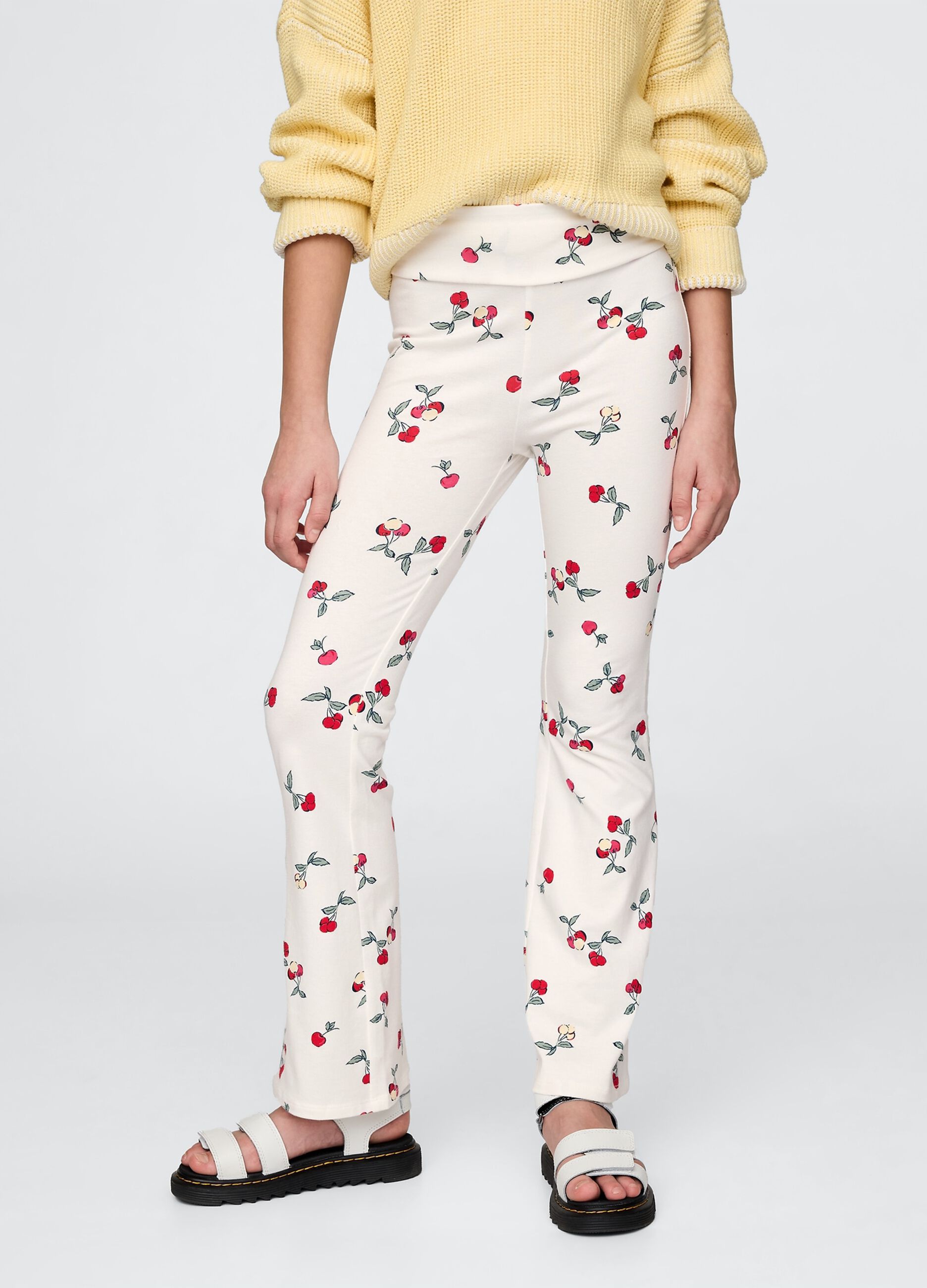 Flared trousers with floral pattern on white background