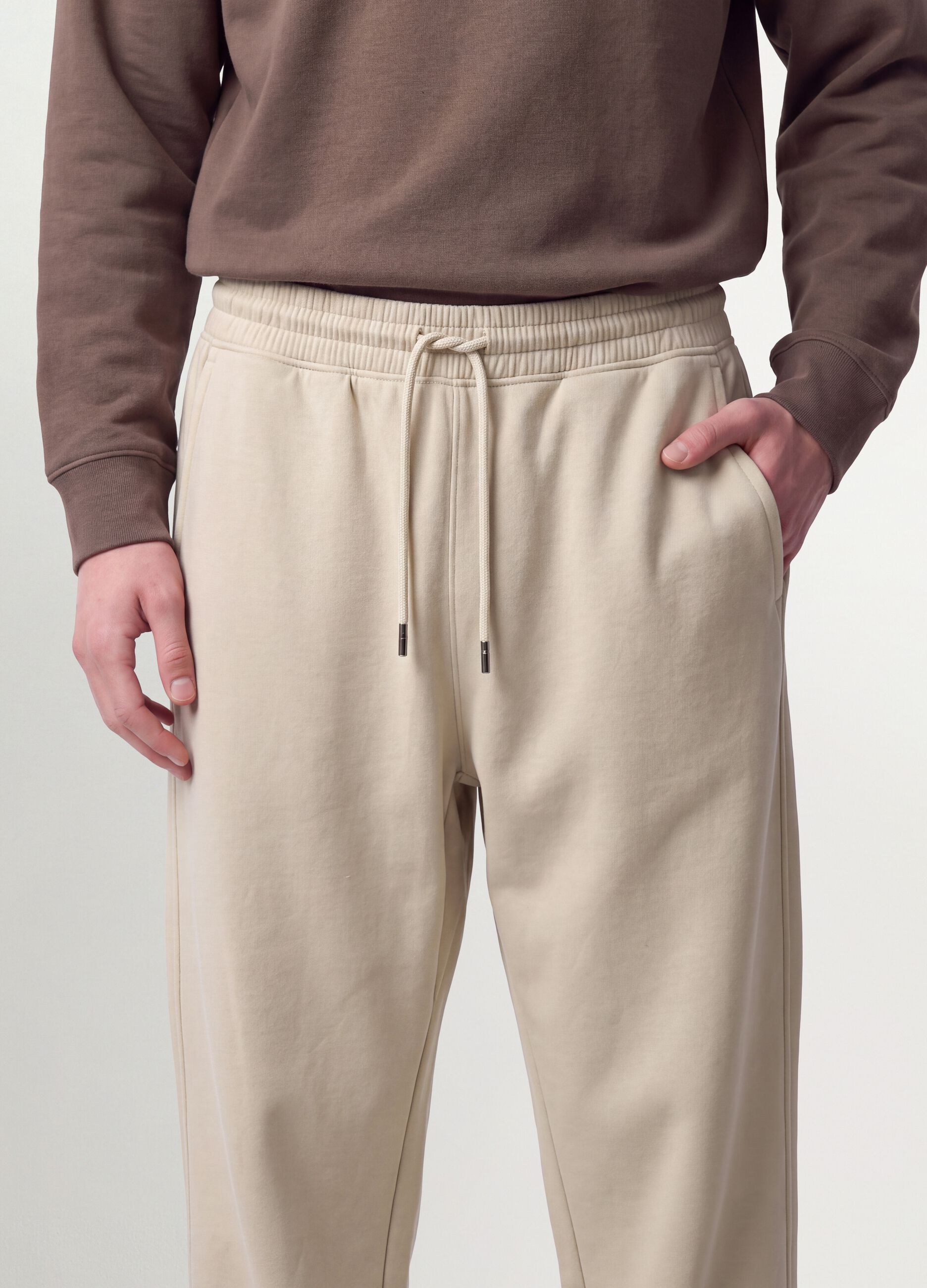 Beige cotton-blend joggers with cuffed hems and drawstring