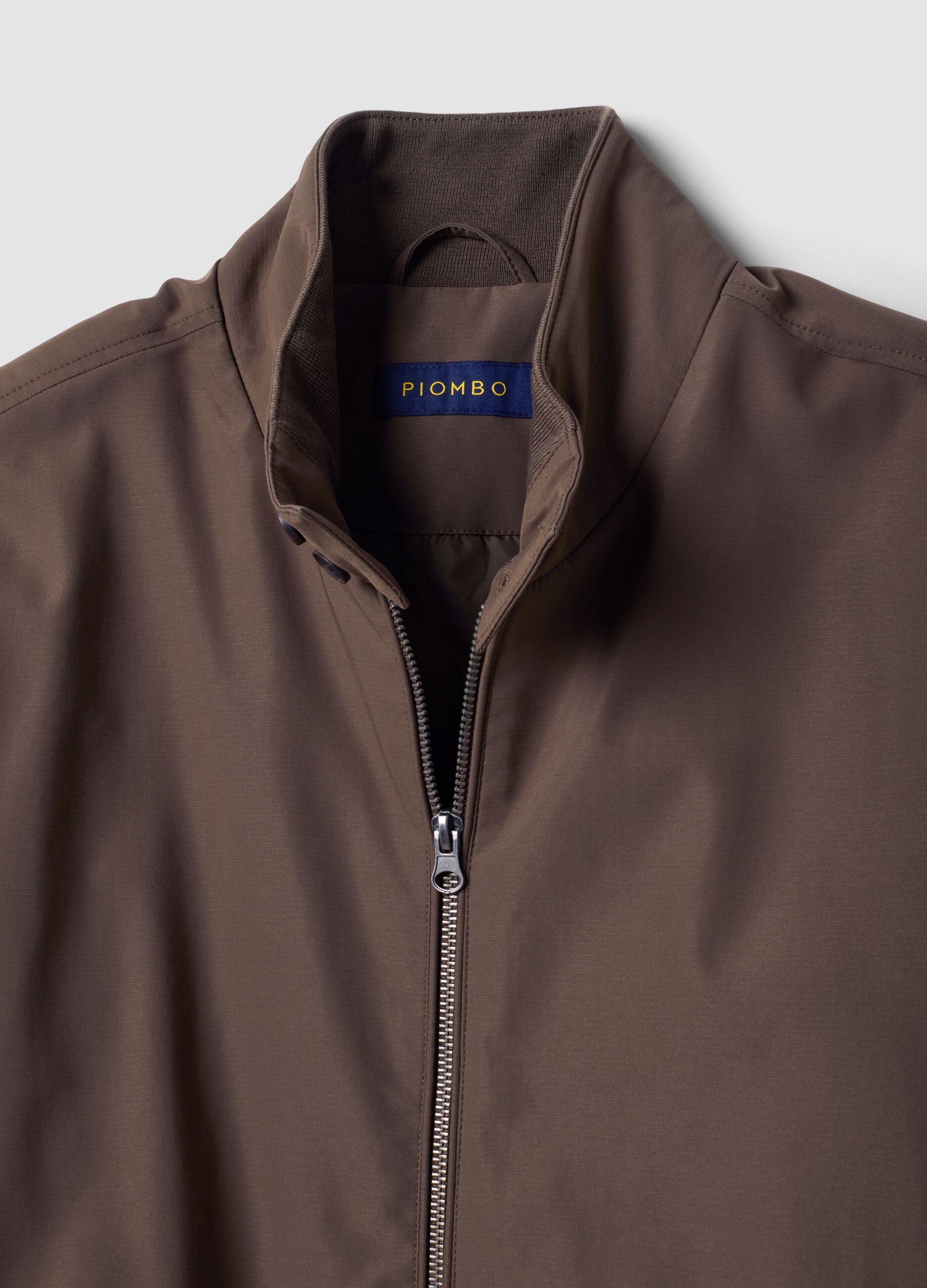 Green padded jacket in a regular fit with zip and high collar