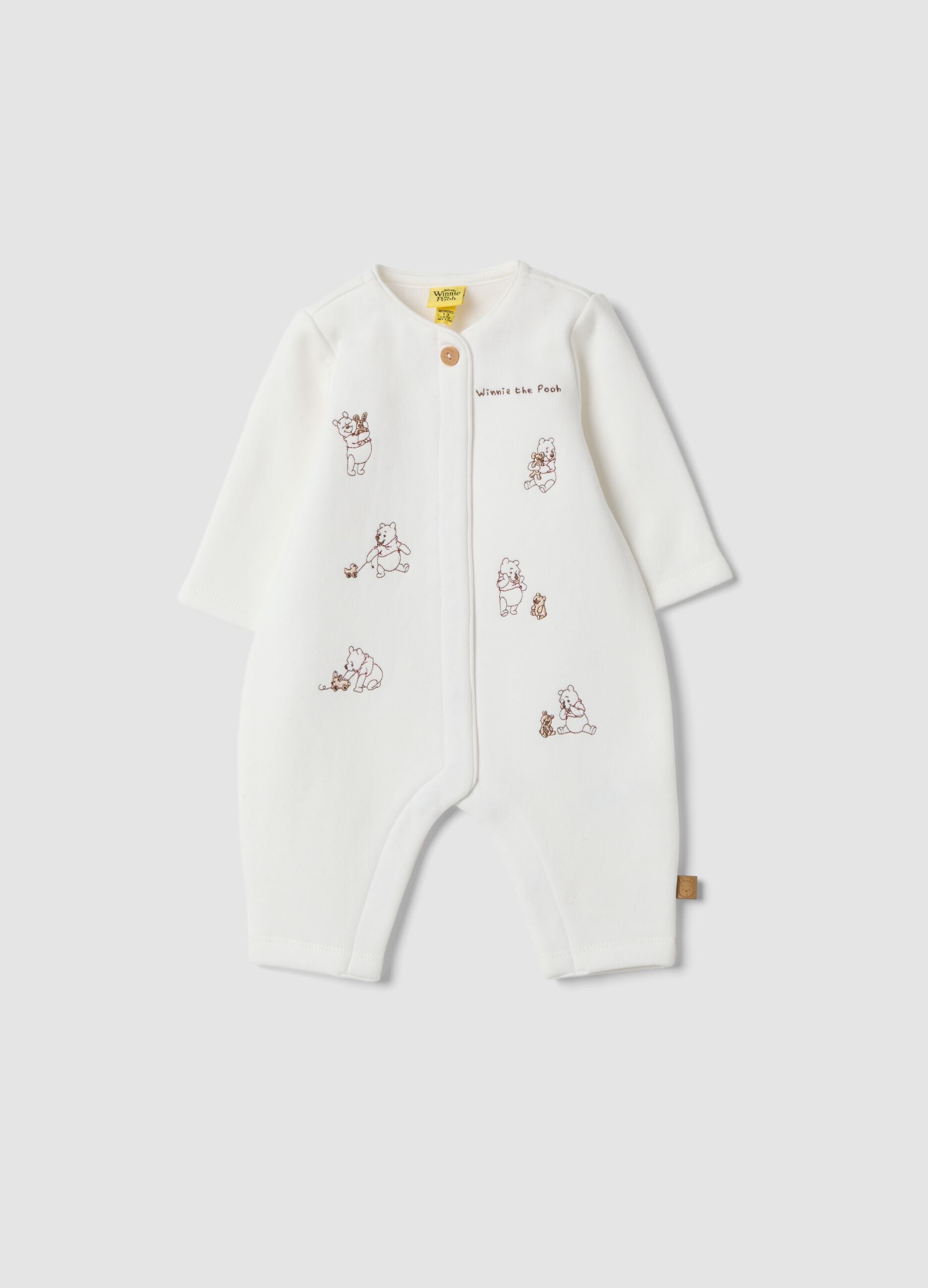Off-white organic cotton sleepsuit with Winnie the Pooh print