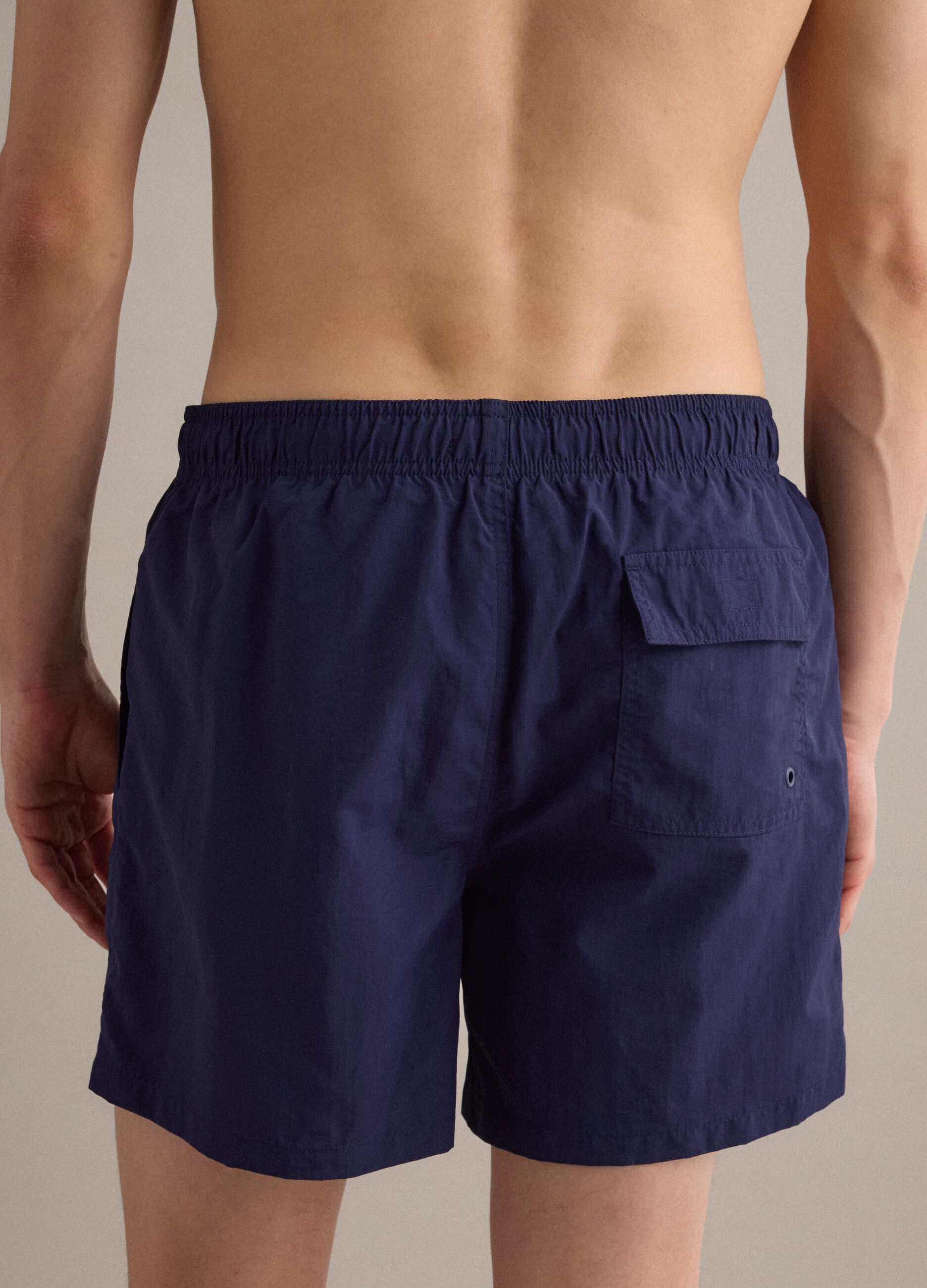 Blue swim shorts with elasticated waistband and drawstring