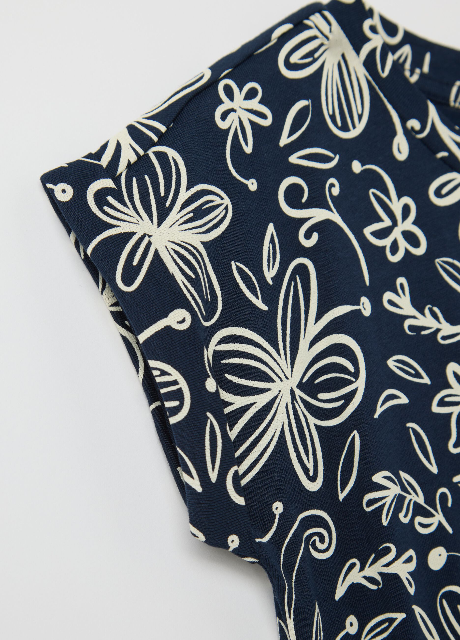 Blue sleeveless dress with floral motifs