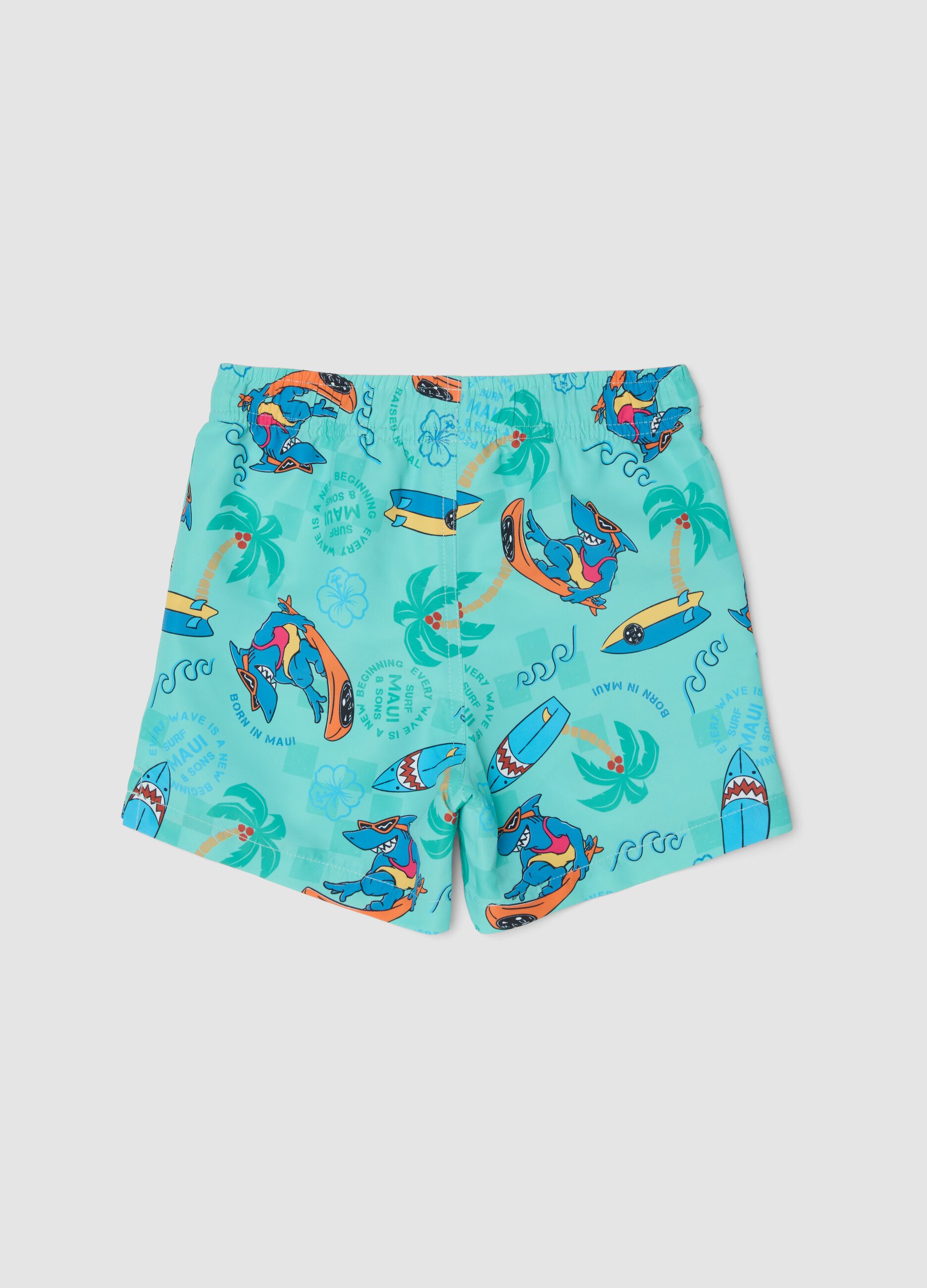 Blue boys&rsquo; swim shorts with tropical print