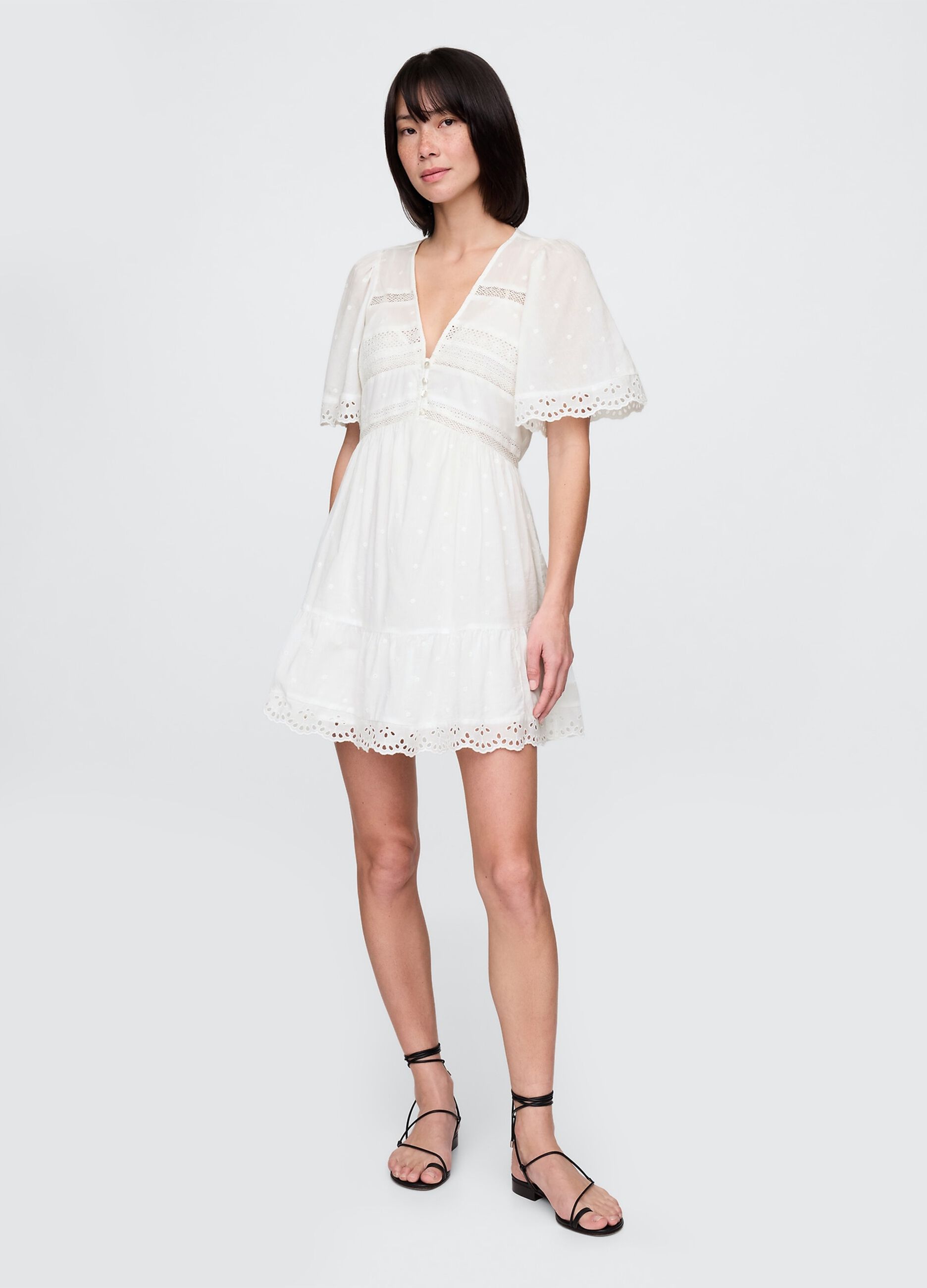 Short white dress in embroidered fabric