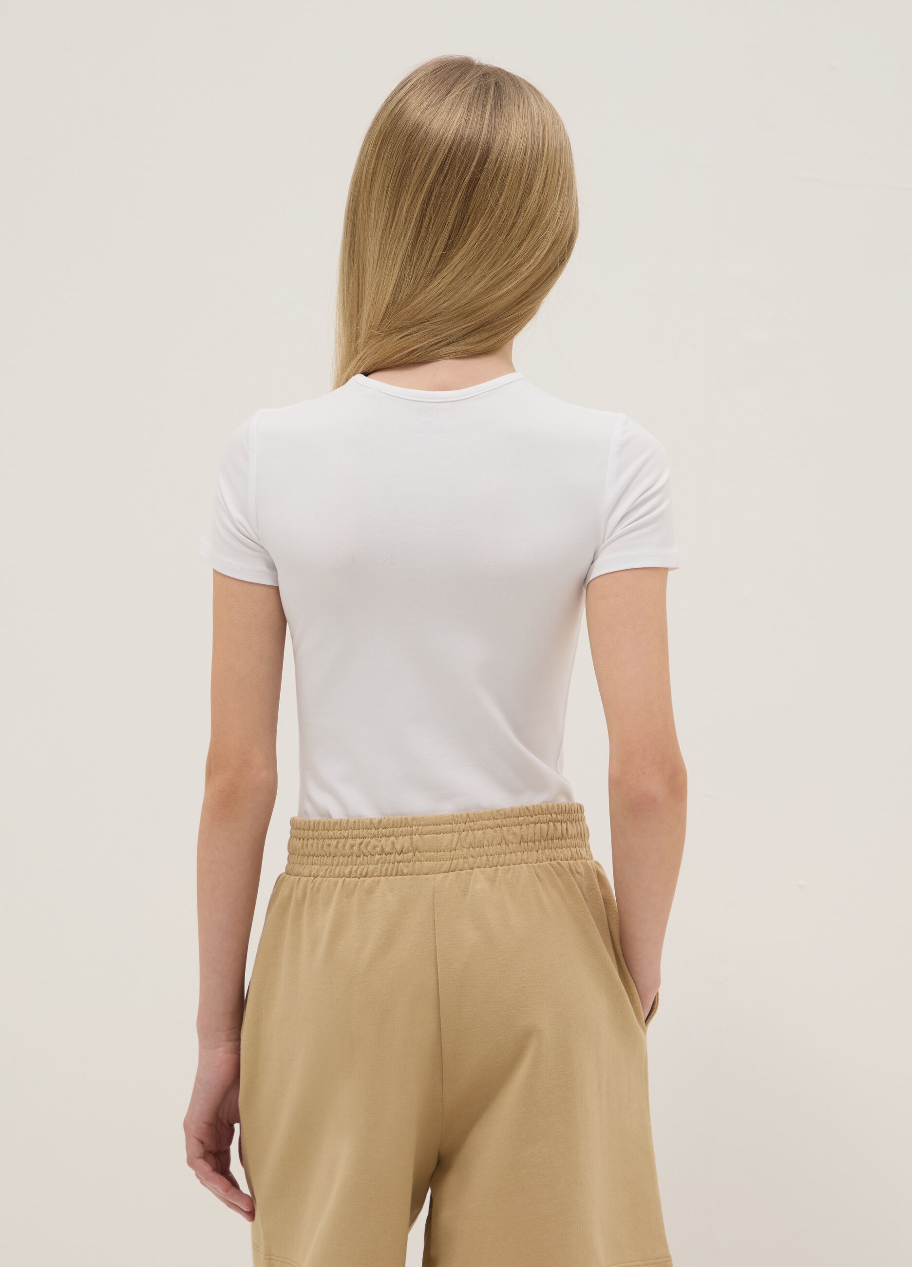 Girl's fitted white stretch cotton bodysuit