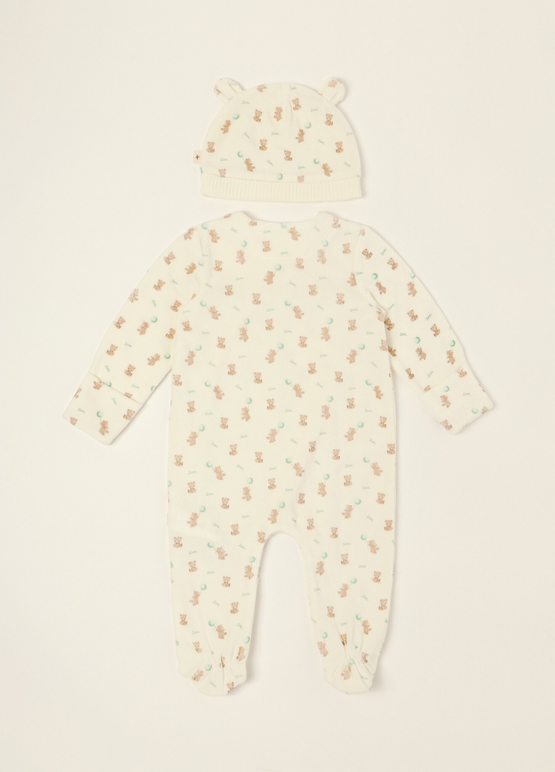 White baby sleepsuit with teddy bear print