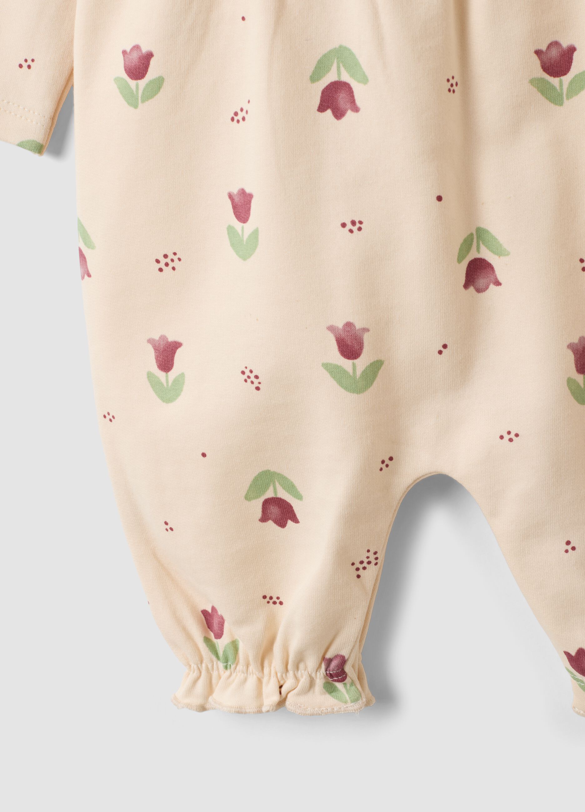 Tutina beige in puro cotone organico con stampa floreale per neonata
