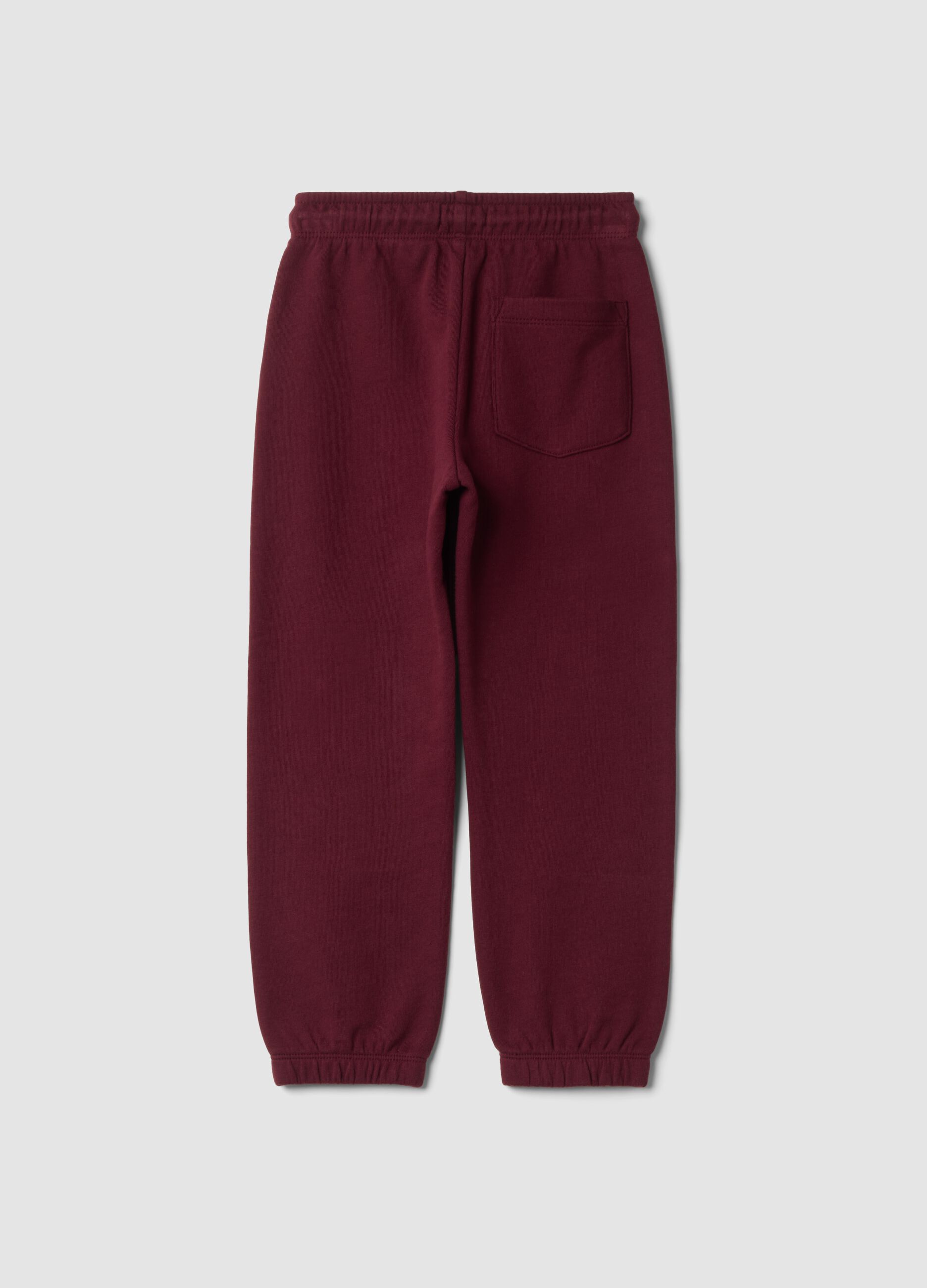 Pantaloni jogger rossi in puro cotone con stampa