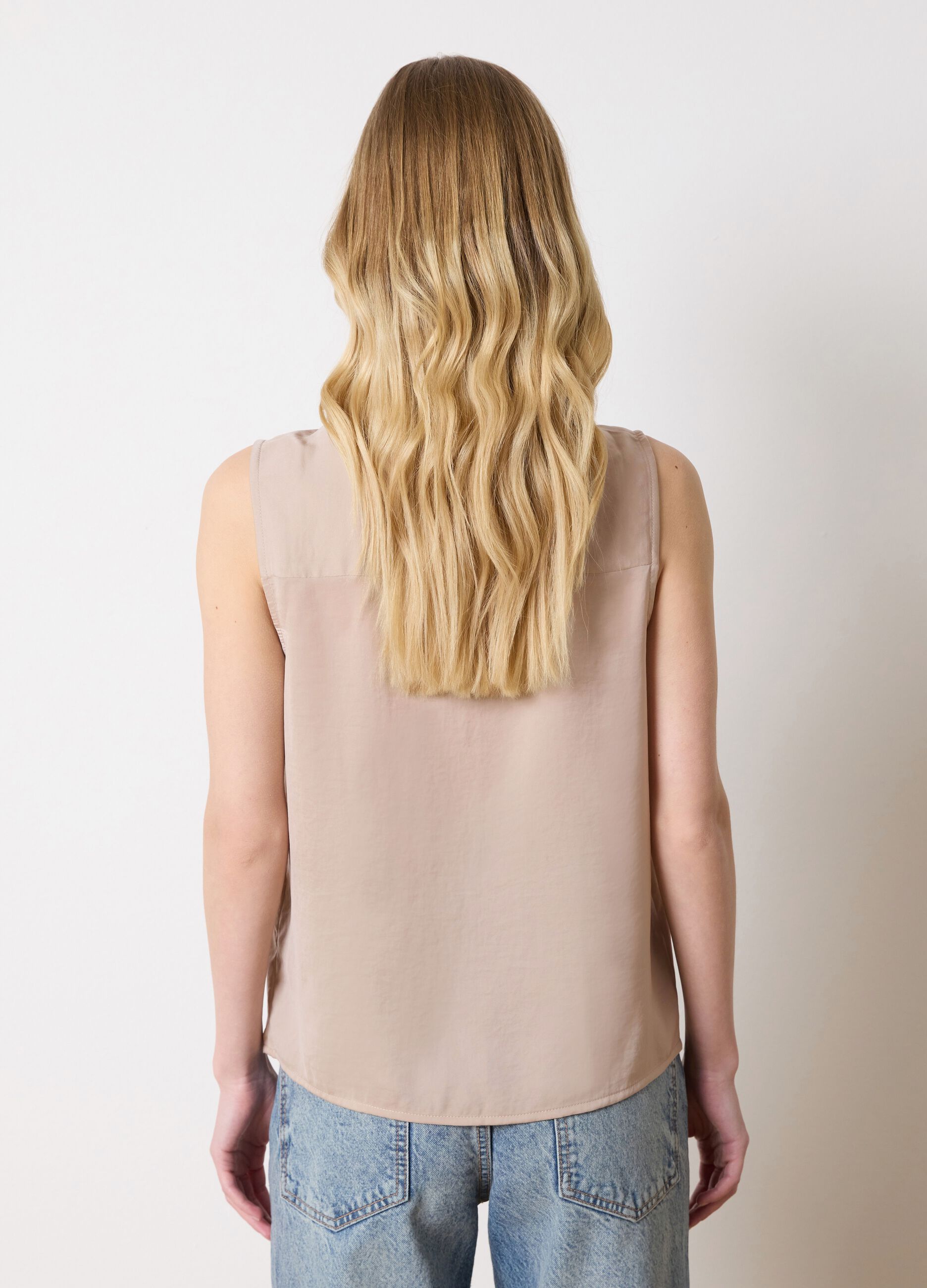 Beige sleeveless blouse with flounce