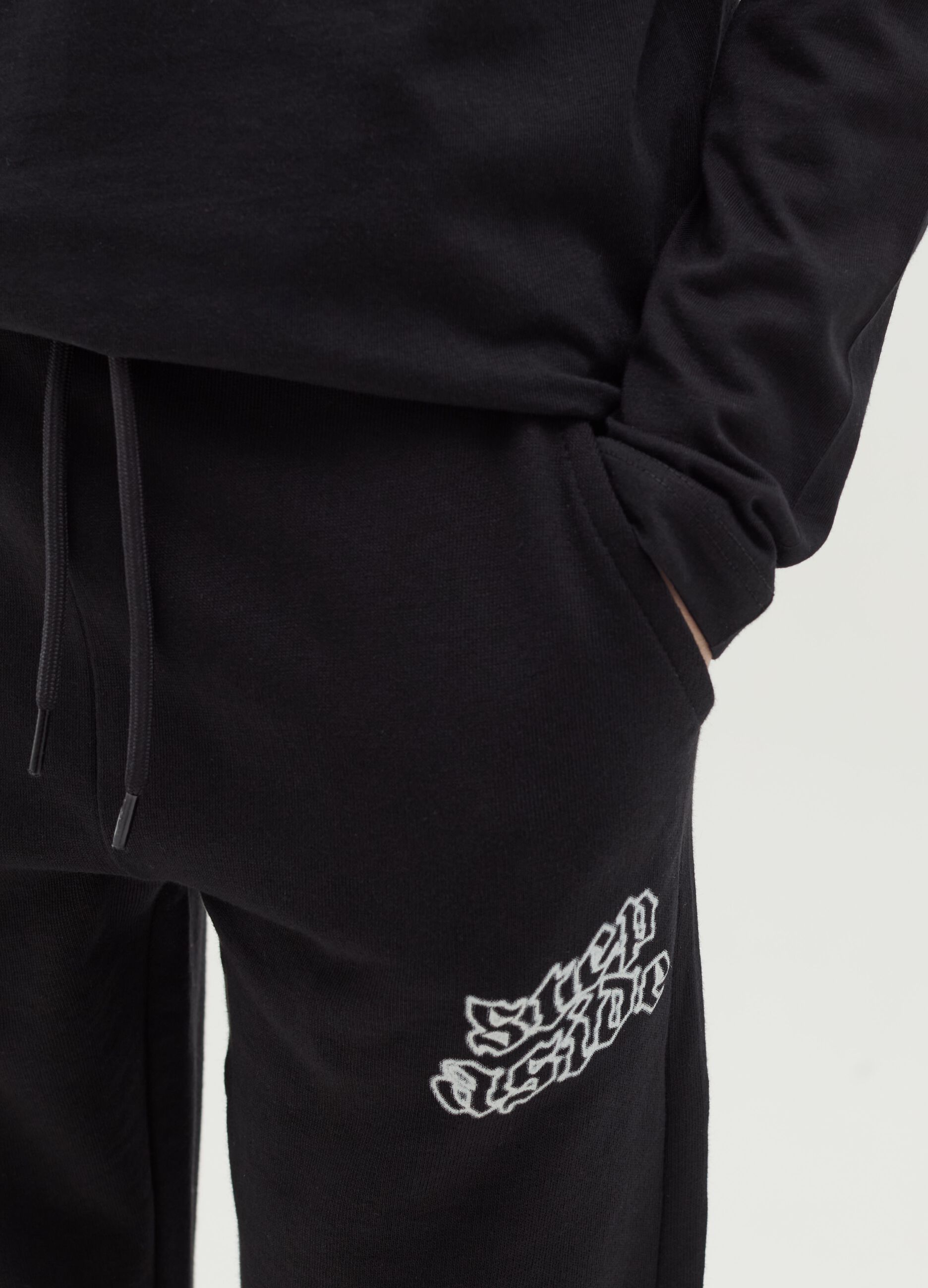 Joggers with drawstring and "Step Aside" print