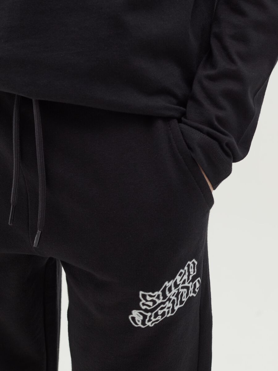 Joggers with drawstring and "Step Aside" print_3