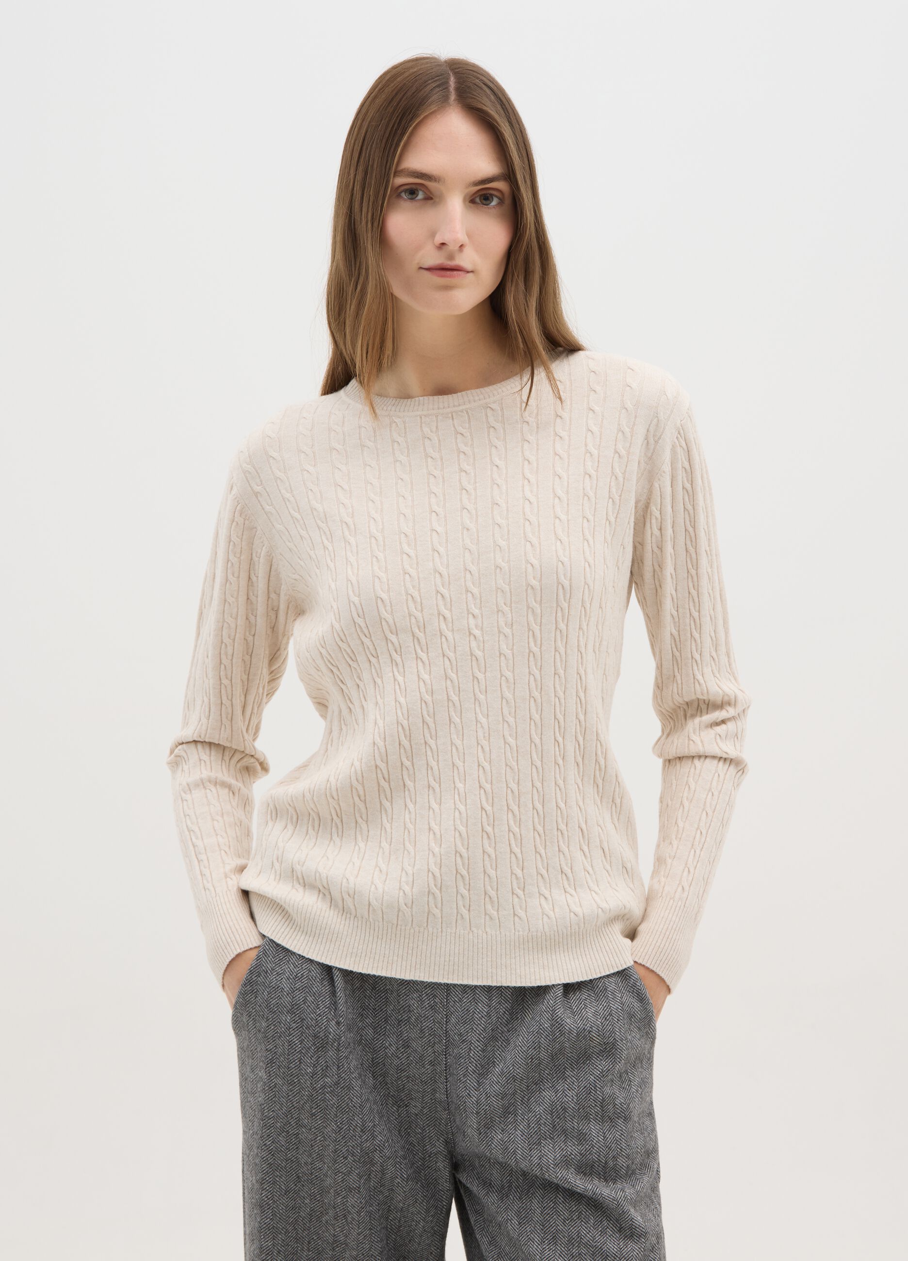 Beige jumper with cable knit design