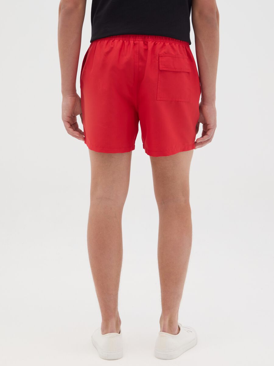 Red swimming trunks with logo print_3