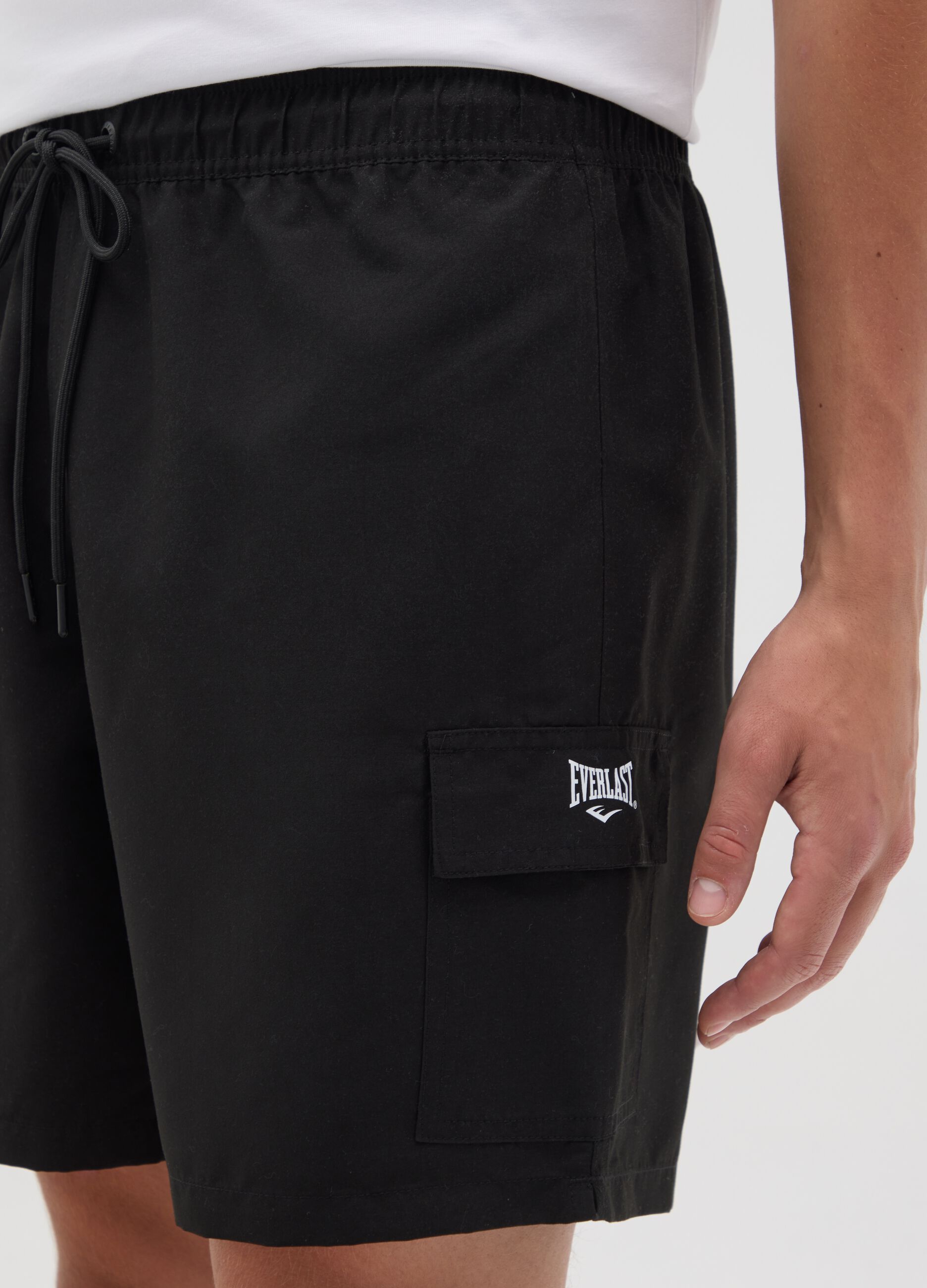Black swimming trunks with logo print