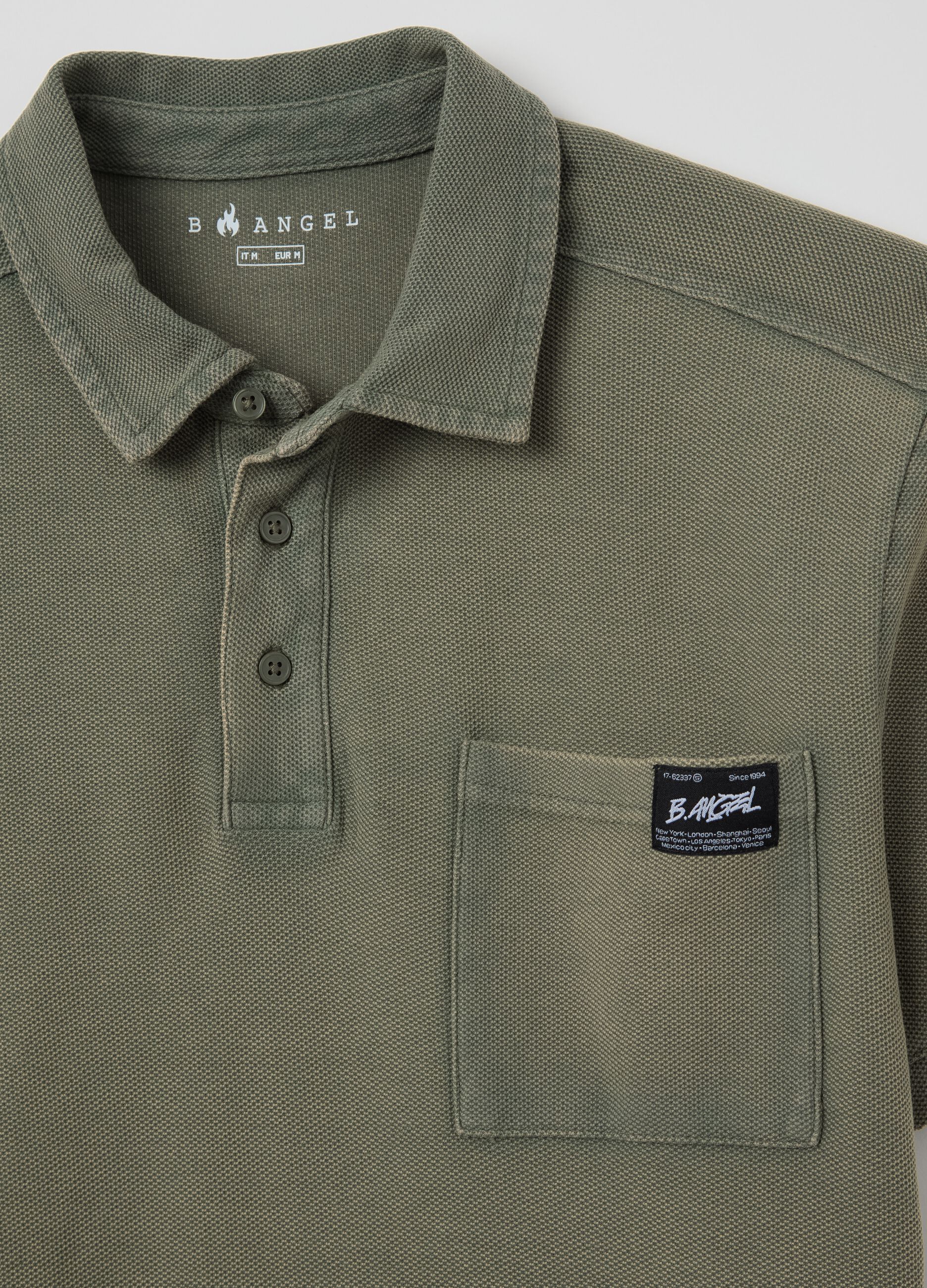 Green short-sleeved polo shirt in cotton piquet