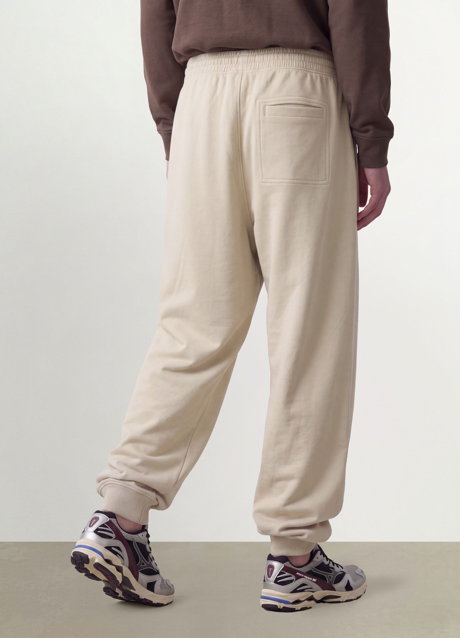 Beige cotton-blend joggers with cuffed hems and drawstring
