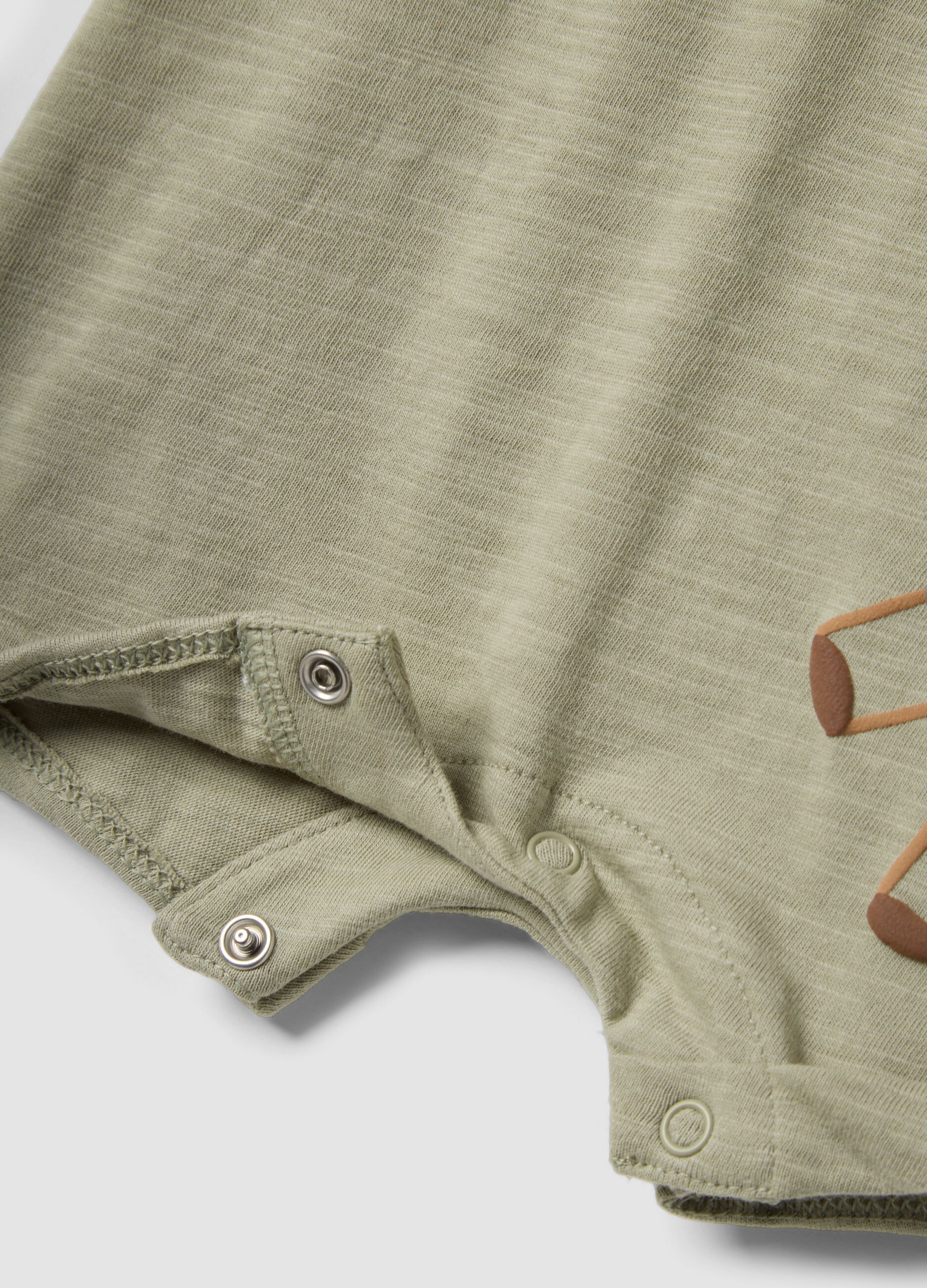 Green organic cotton baby romper with animal print