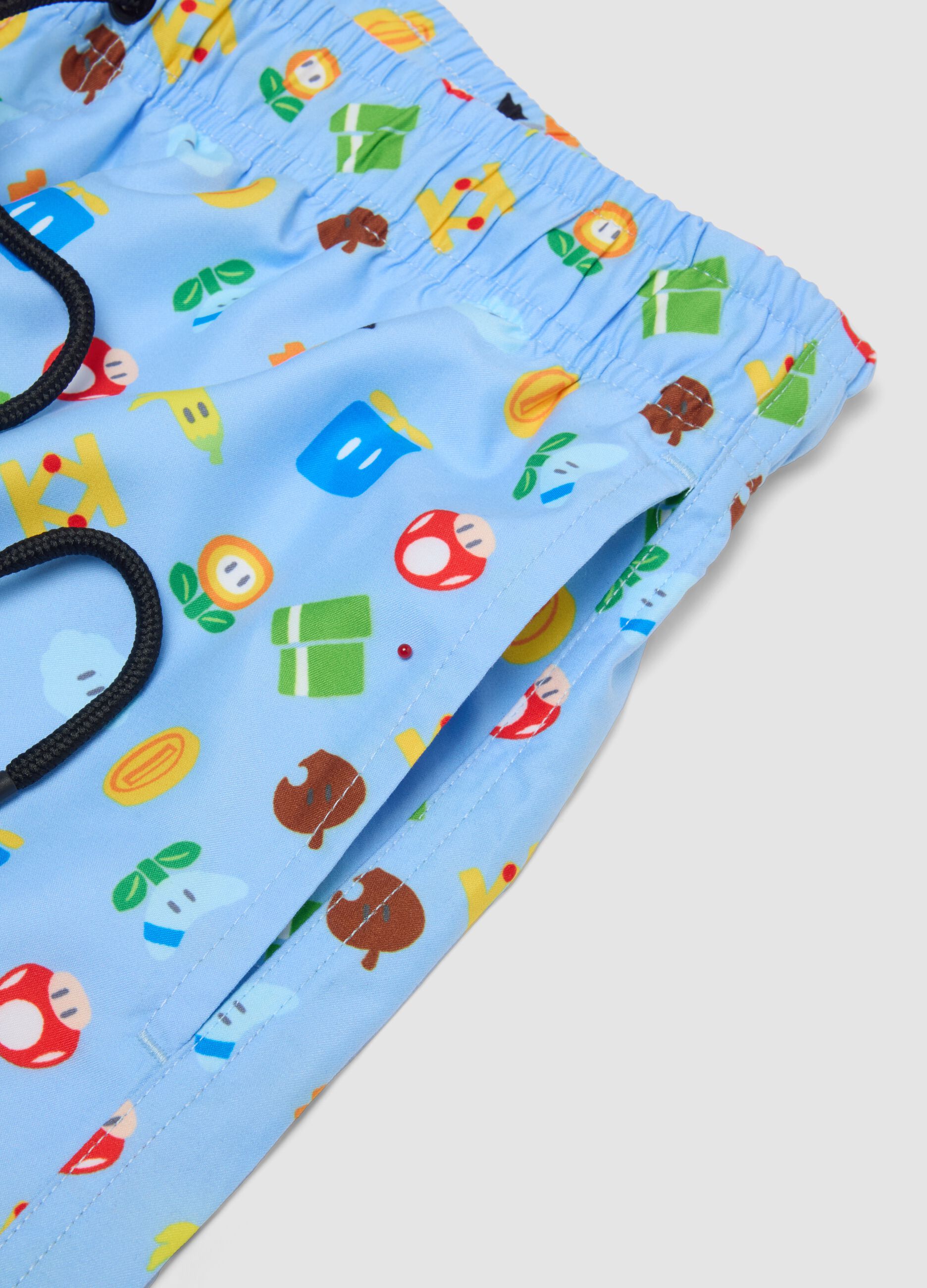 Blue swim shorts with Super Mario prints